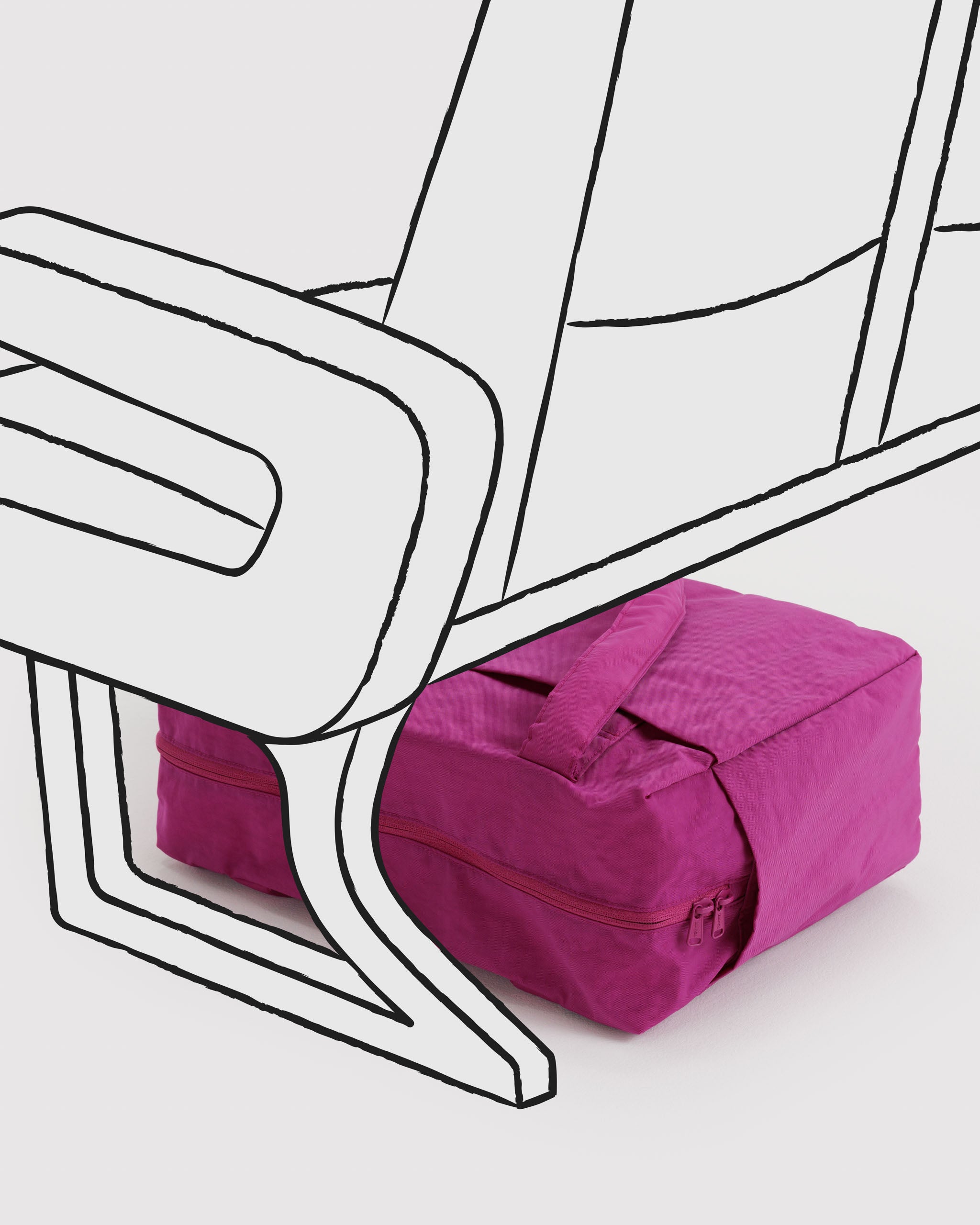 Vibrant pink travel bag under a white airplane seat.