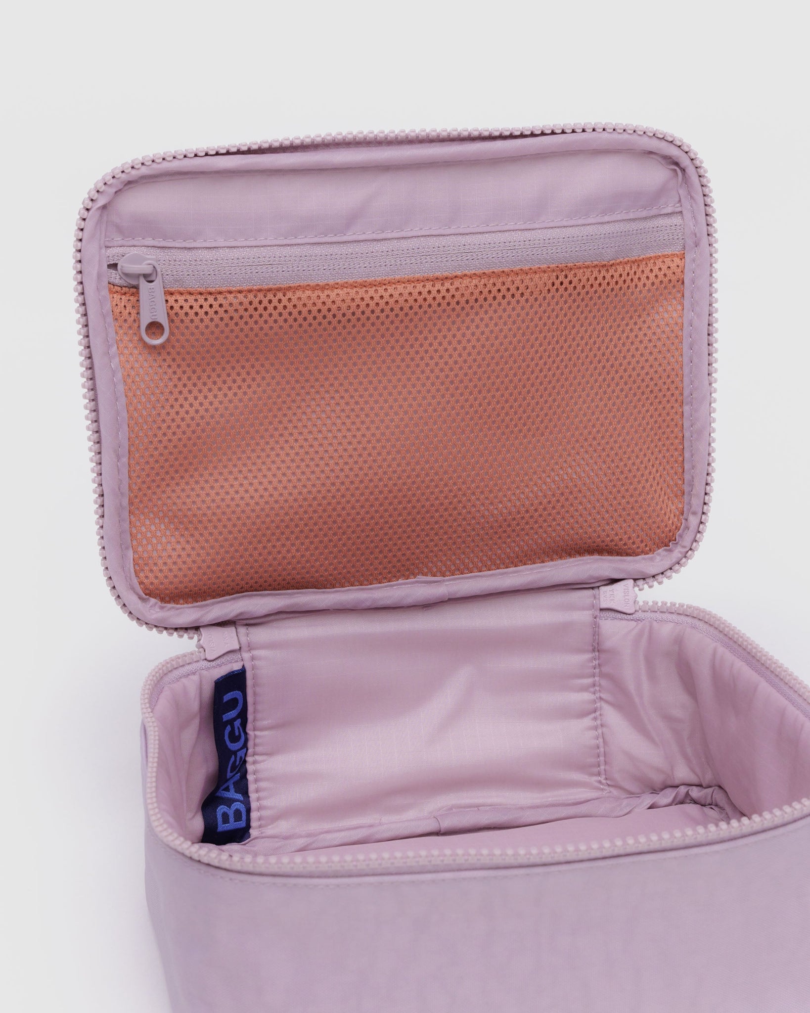 Empty dusty pink small cosmetic case with zipper top lid open.