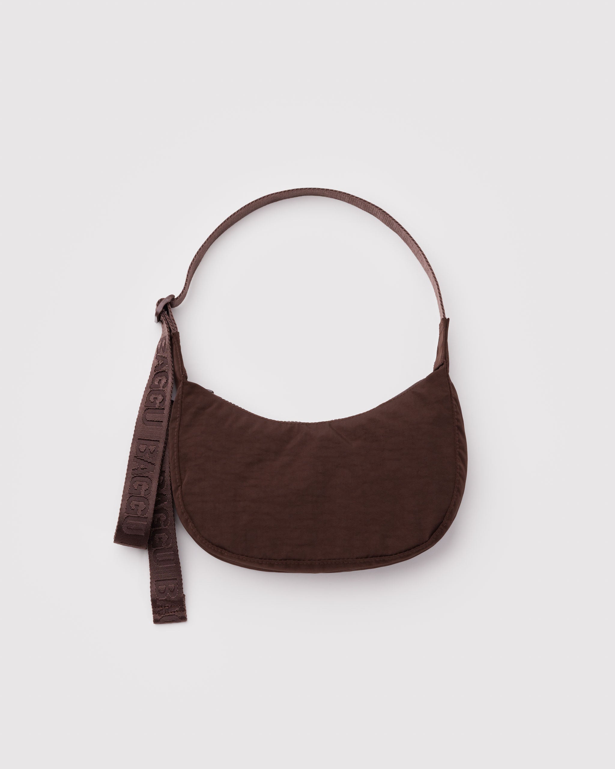 Brown shoulder bag with an adjustable strap and zip top.