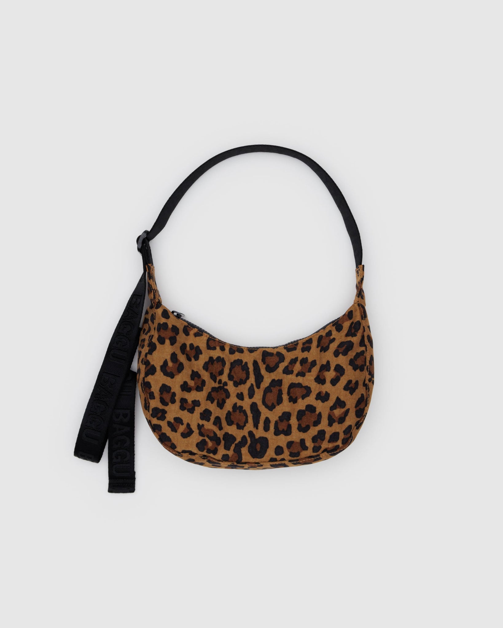Leopard print handbag with a black adjustable strap.