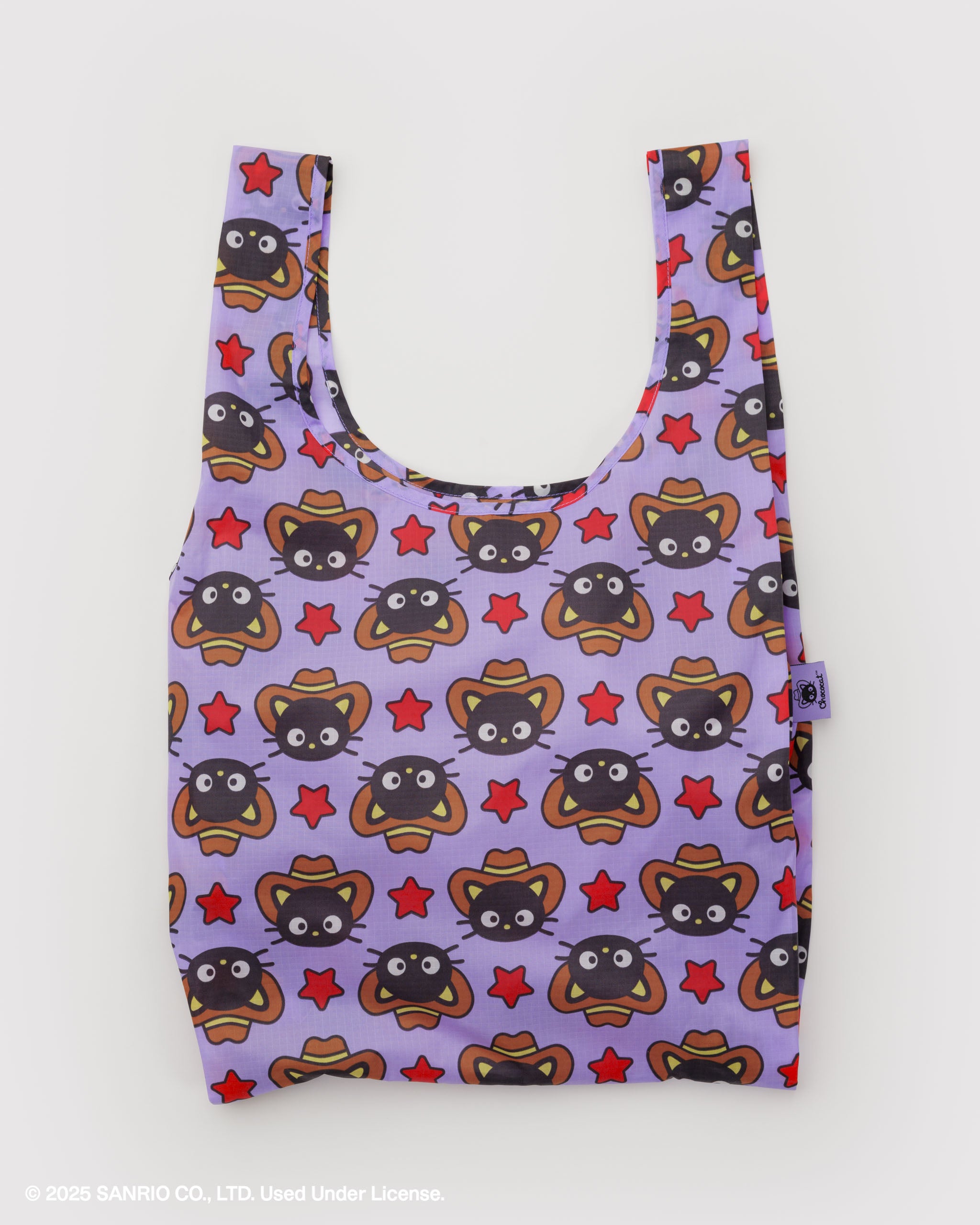 Reusable bag with chocolate cat face pattern and red stars on a purple background.