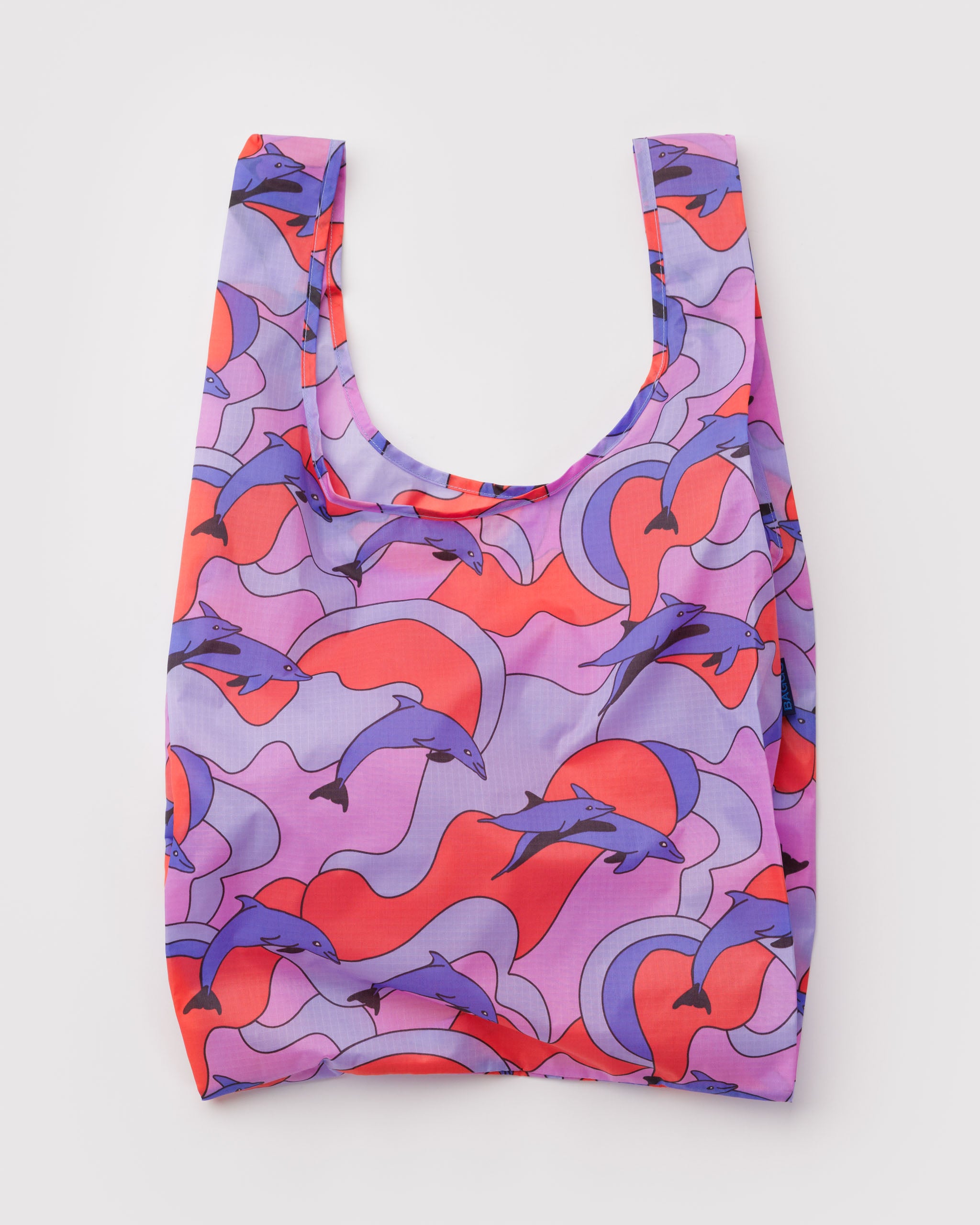 Reusable bag with dolphin pattern on a purple, orange and blue backgroound