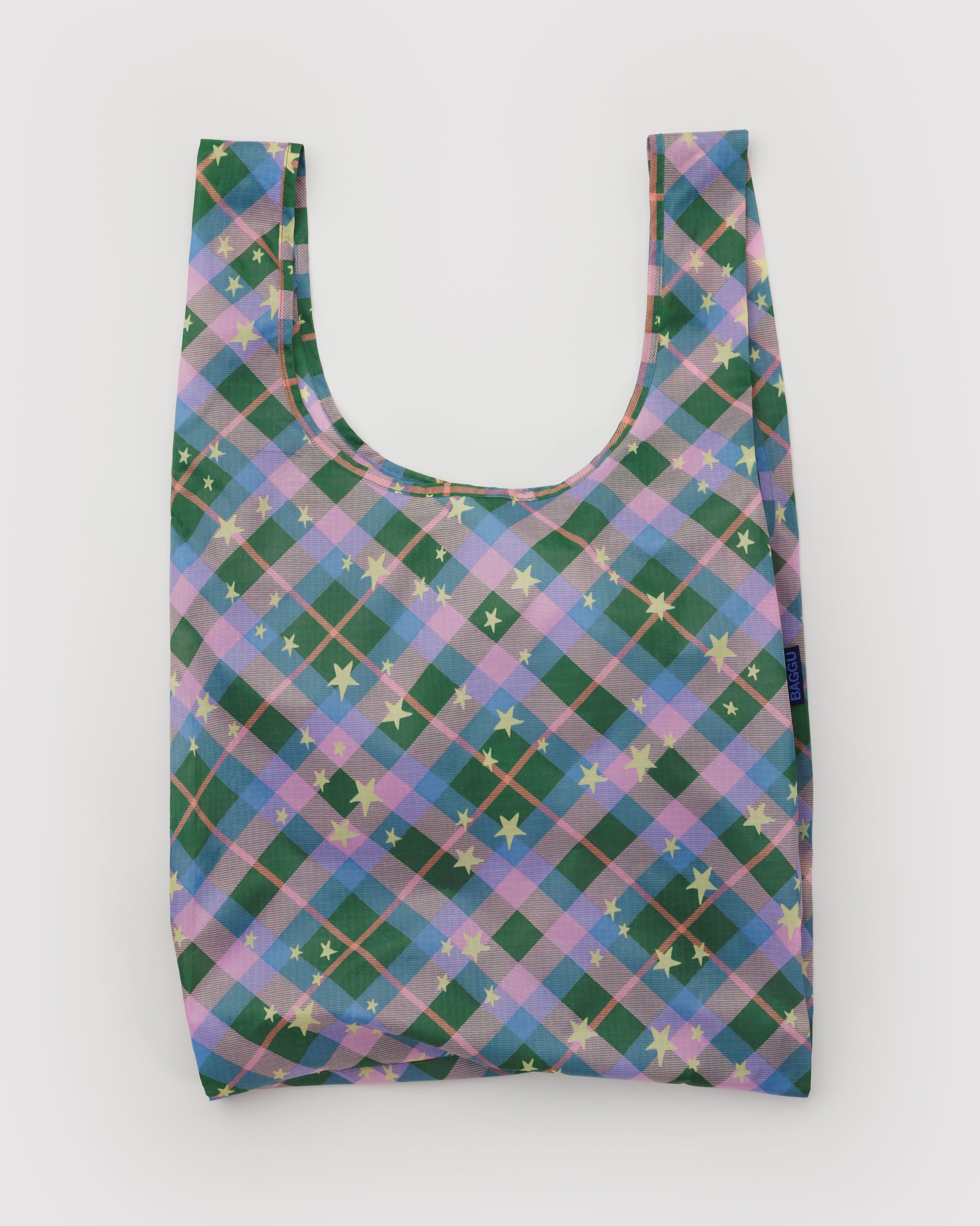 Reusable bag with a green and purple plaid pattern and stars.