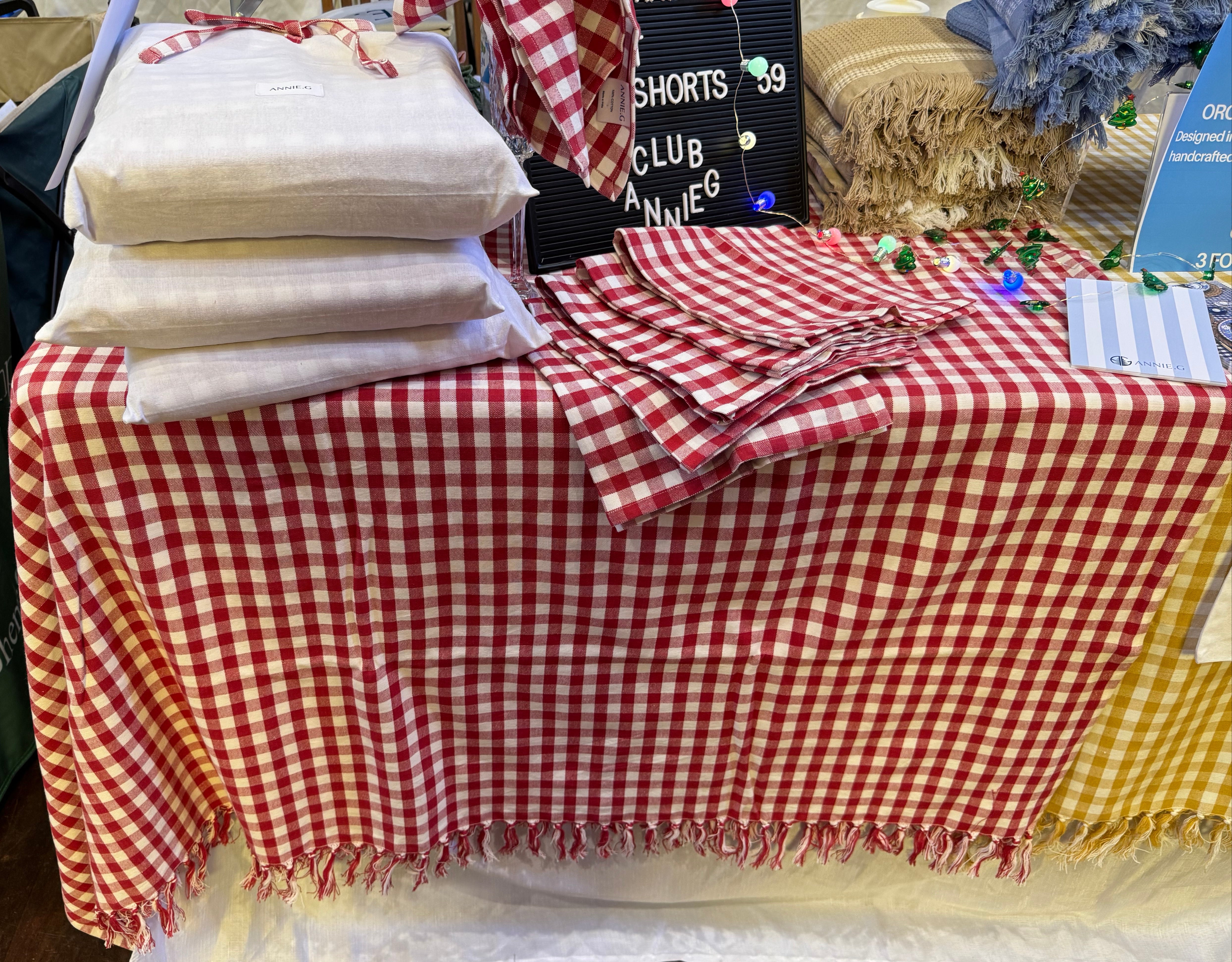 red-gingham-hand-knotted-edge-tablecloth-on-table