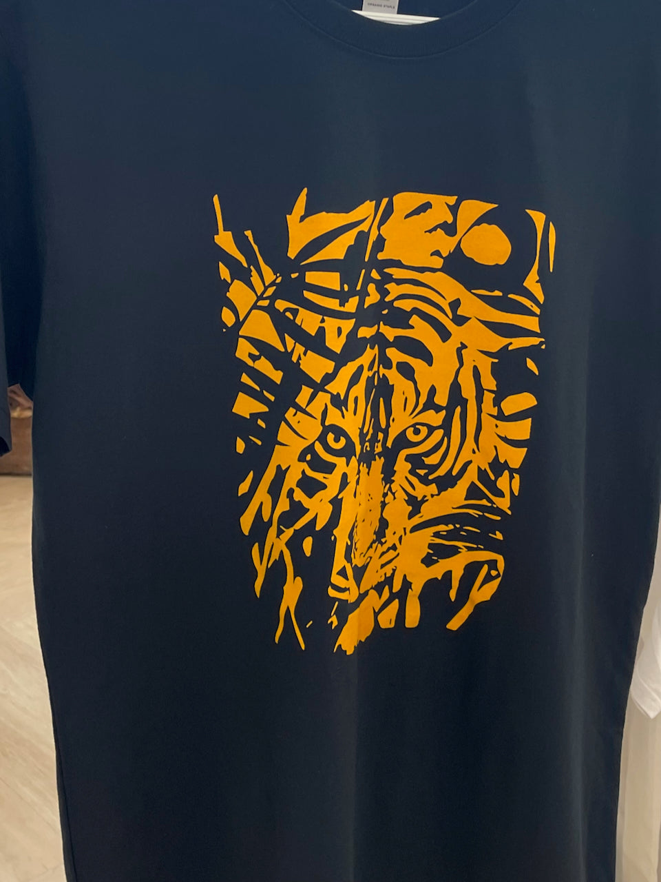 hanging-navy-t-shirt-with-orange-tiger-screenprint-front