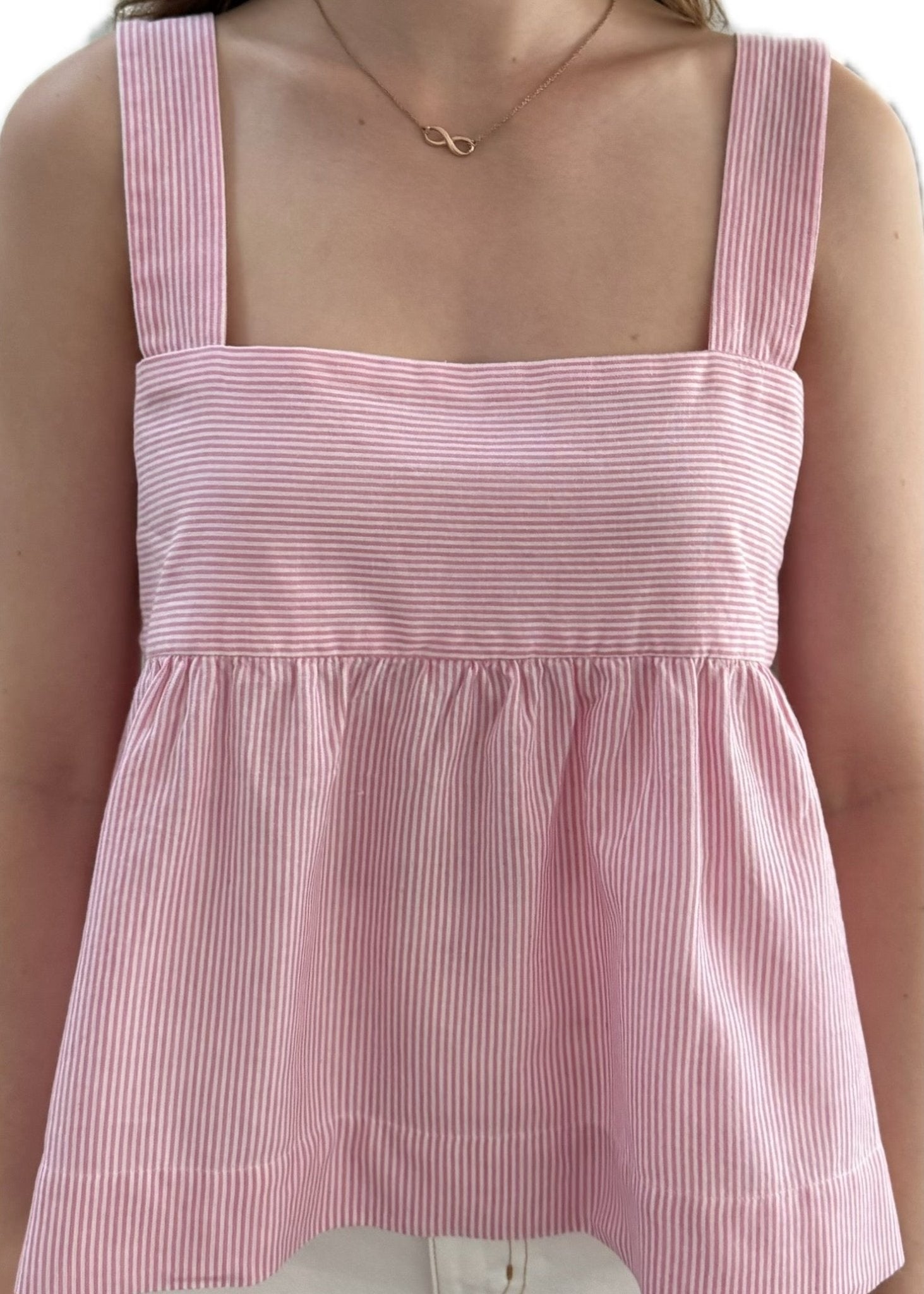 Woman wearing pink stripe cami top.