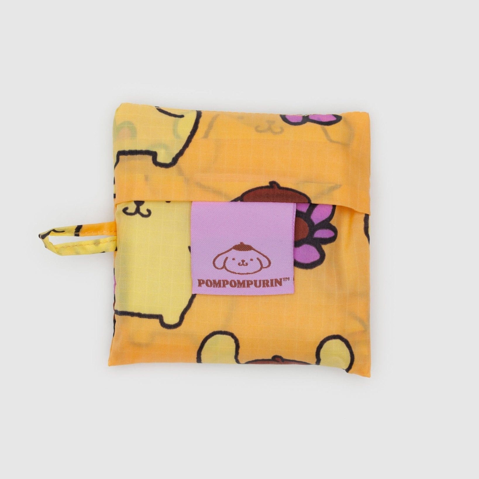 Yellow storage pouch with golden dog cartoon character design and Pompompurin logo and loop at side