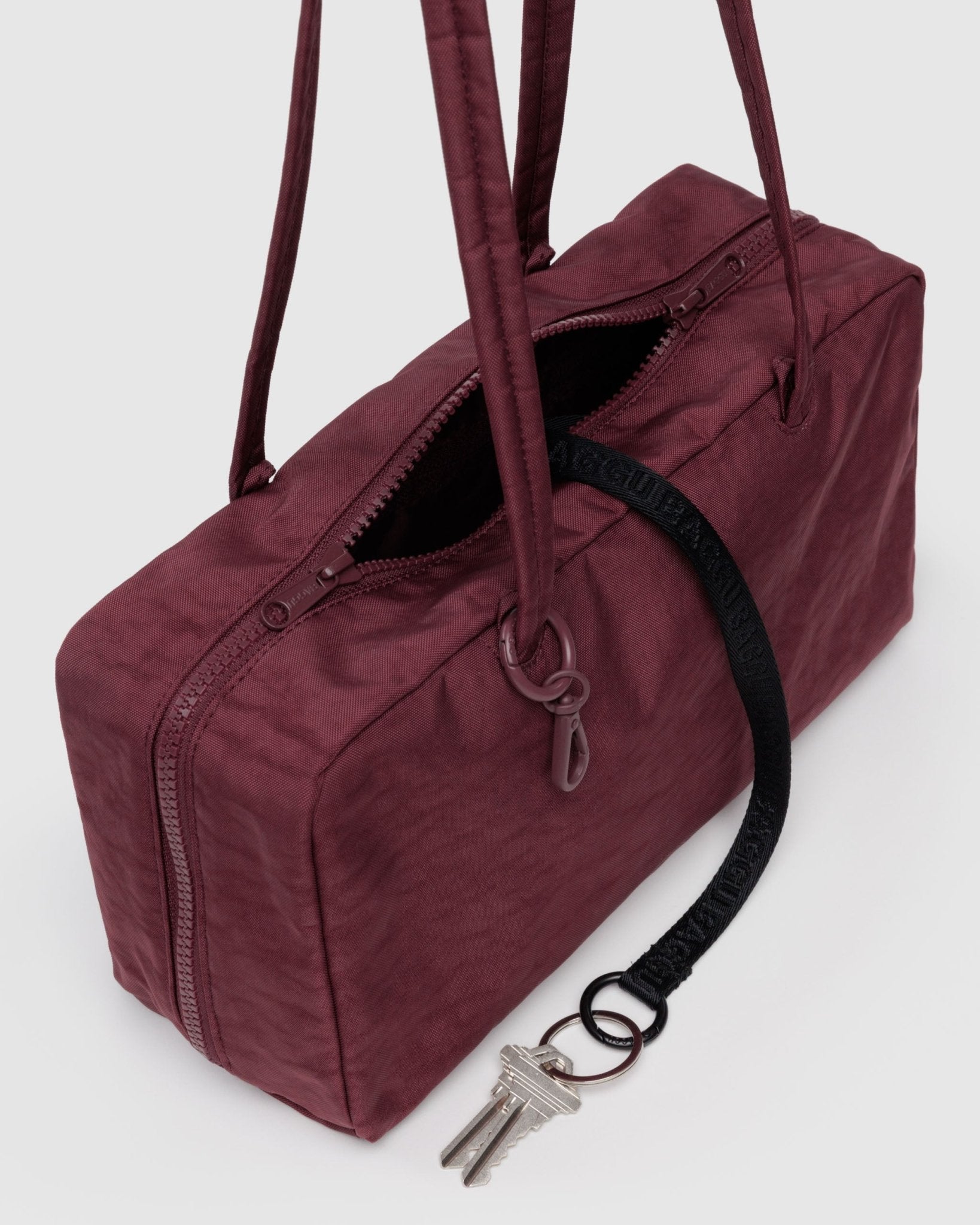 Maroon bowler bag with an internal keychain 