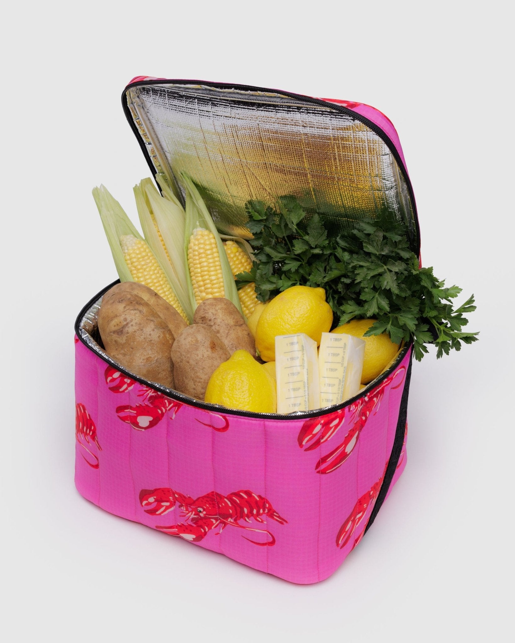 Pink with red lobster printed nylon insulated cooler bag with vegetables and butter inside