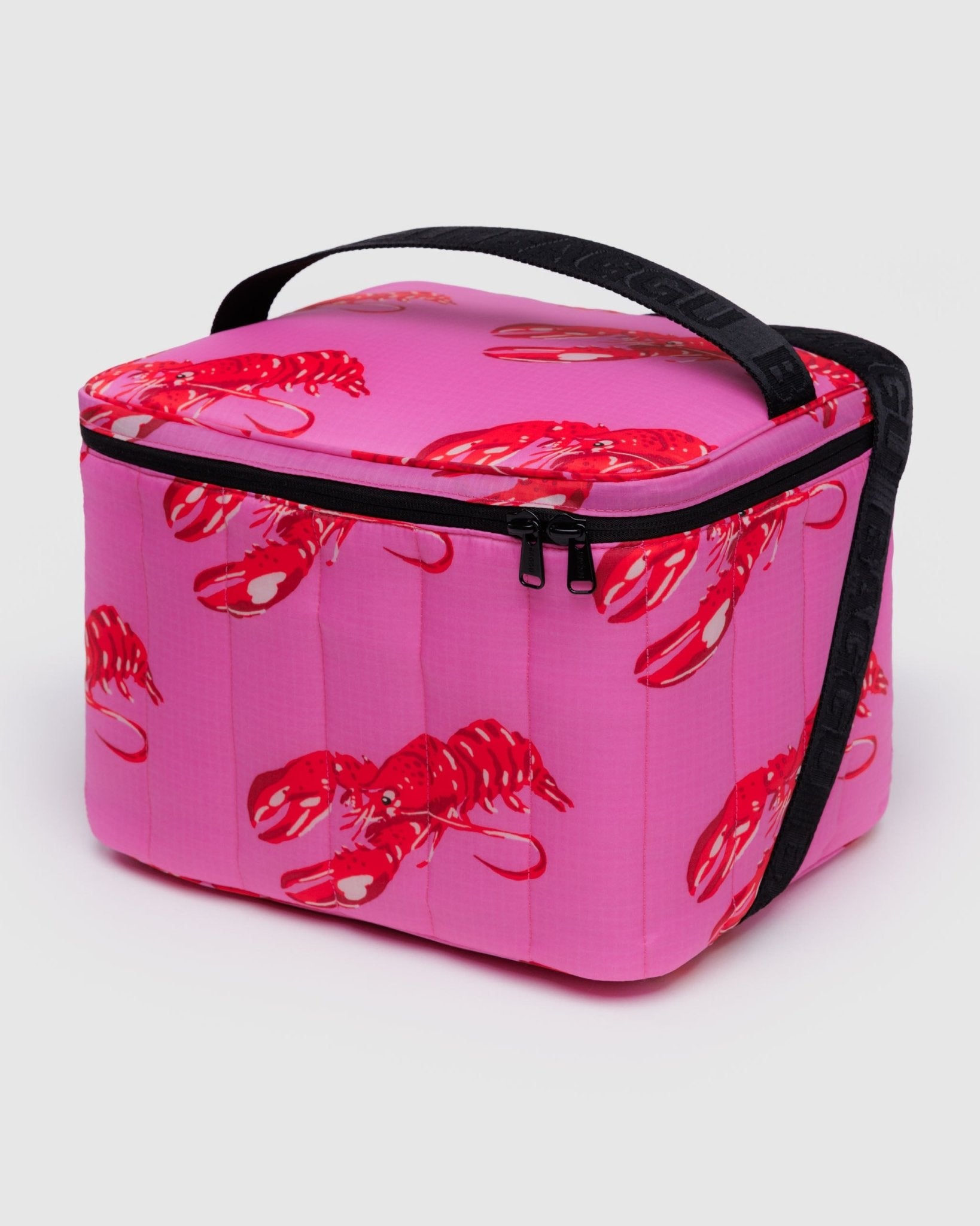 Pink cooler bag with red lobster design and black carry handle and adjustable shoulder strap