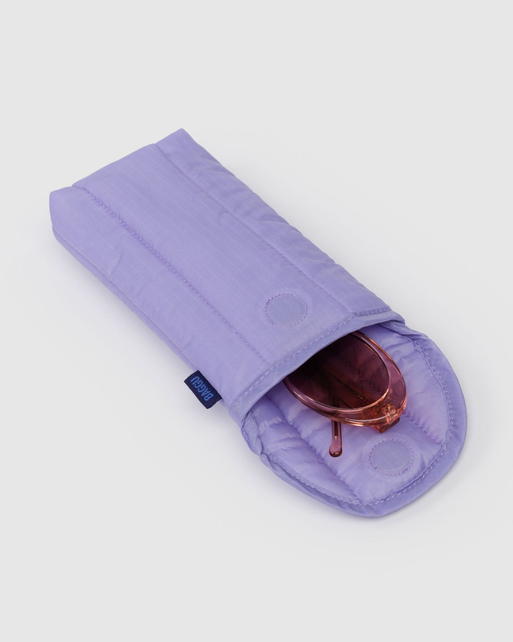 Quilted purple sunglass case with magnetic closure and sunglasses inside