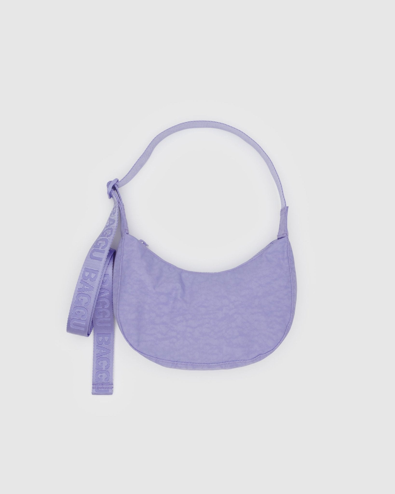 Small purple crescent bag with adjustable crossbody shoulder strap and zip top