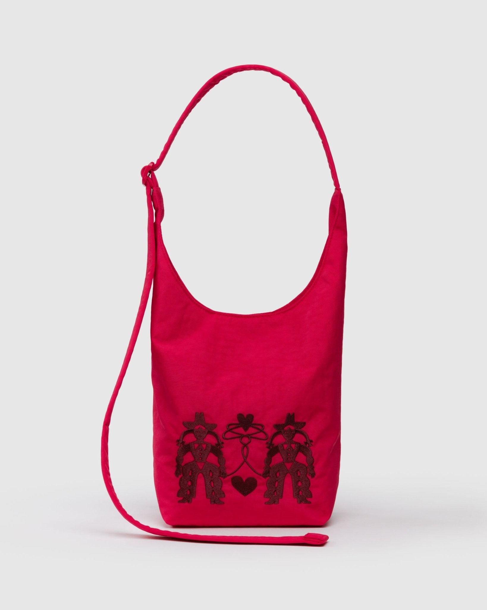 Red bag with black cowgirl and heart designs on a white background