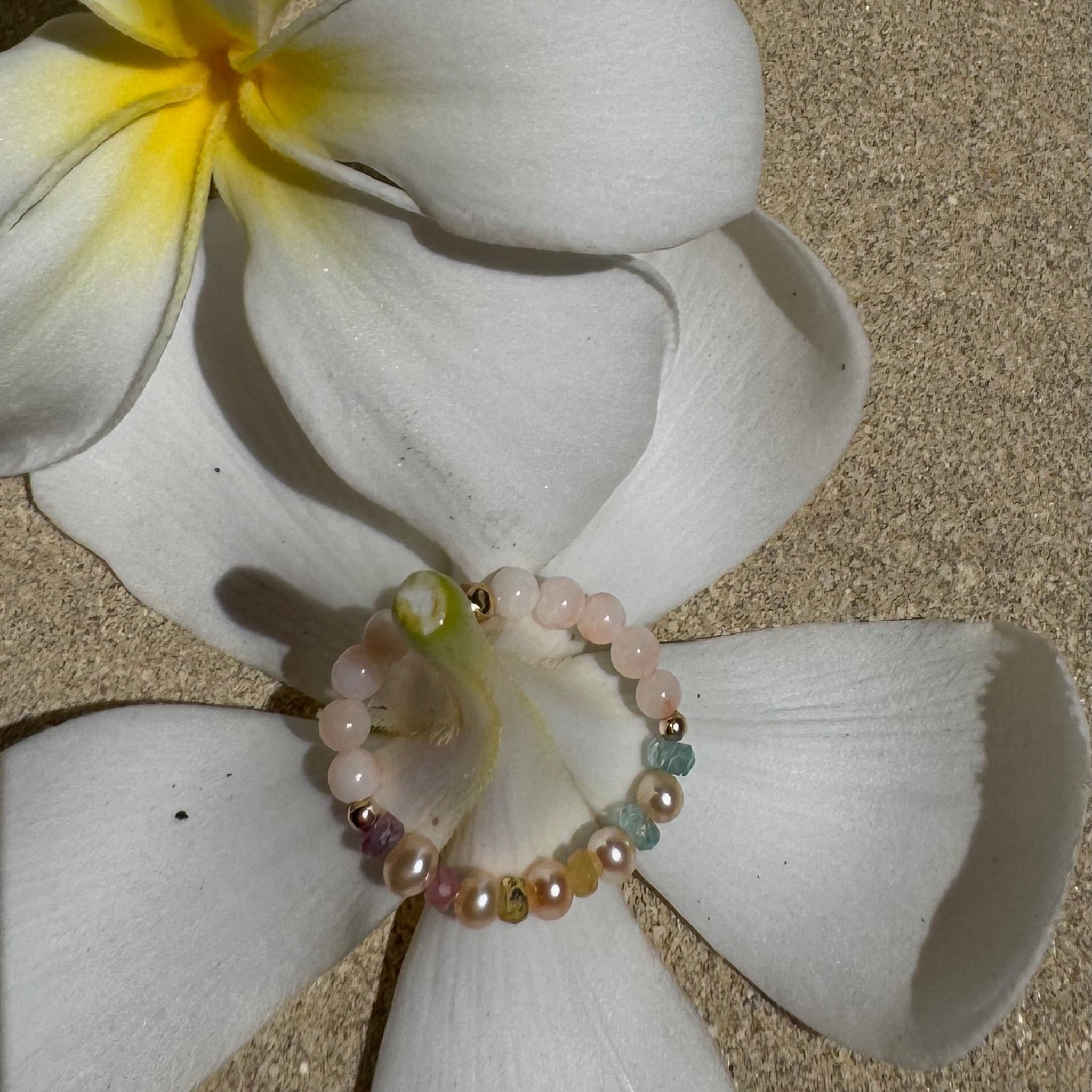 Bead Stretch Ring on a white flower stem