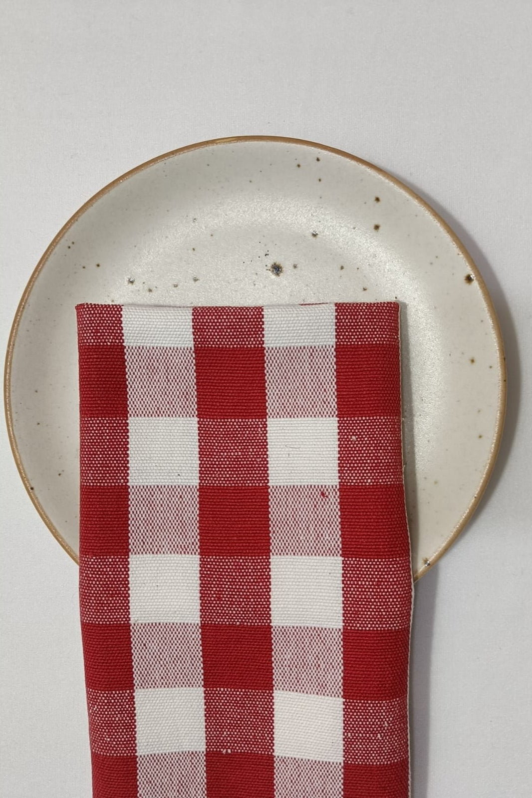 red-check-gingham-napkin-folded-across-a-plate