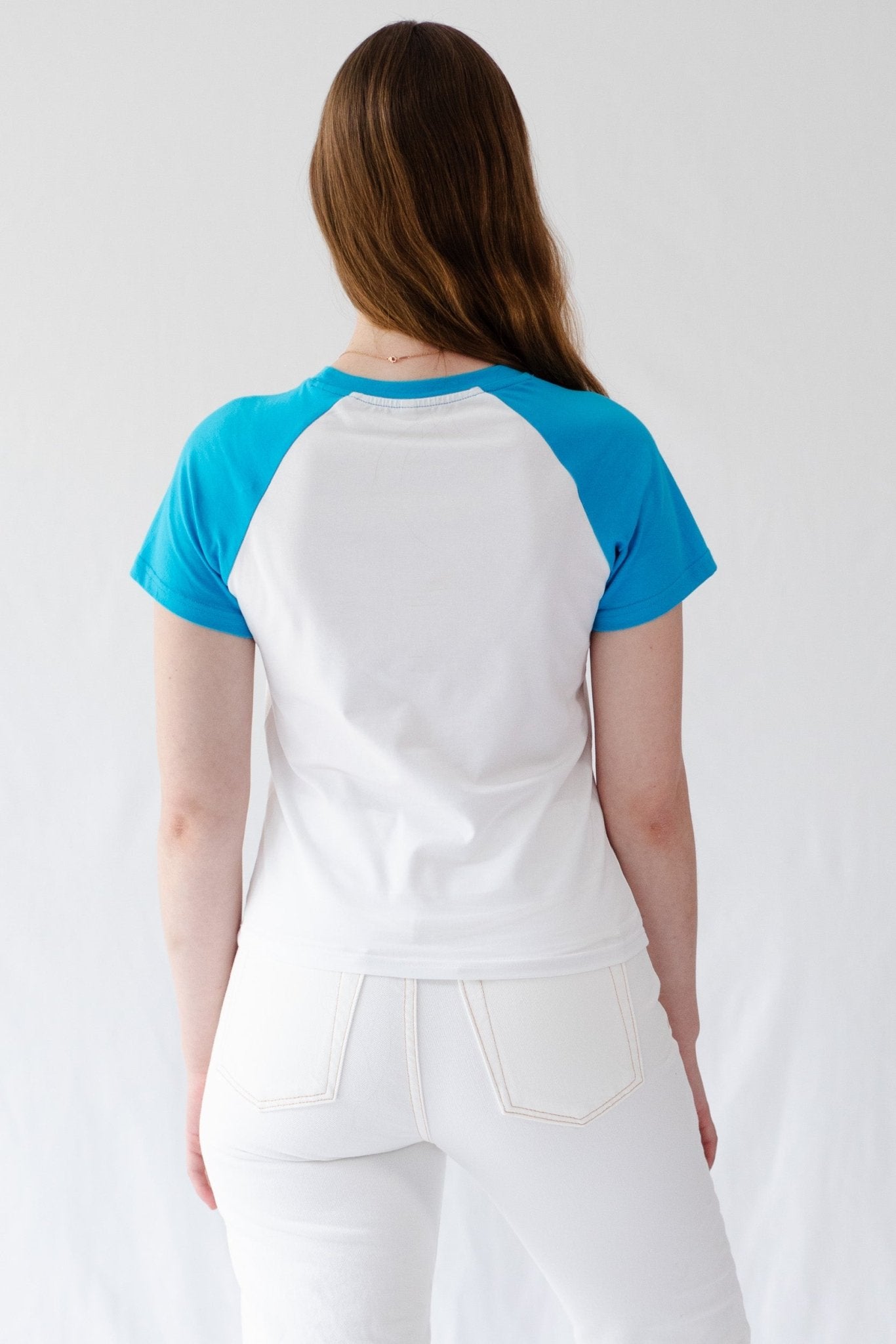 Back of a woman wearing white t-shirt with blue short blue sleeves and crew neck - ANNIE.G