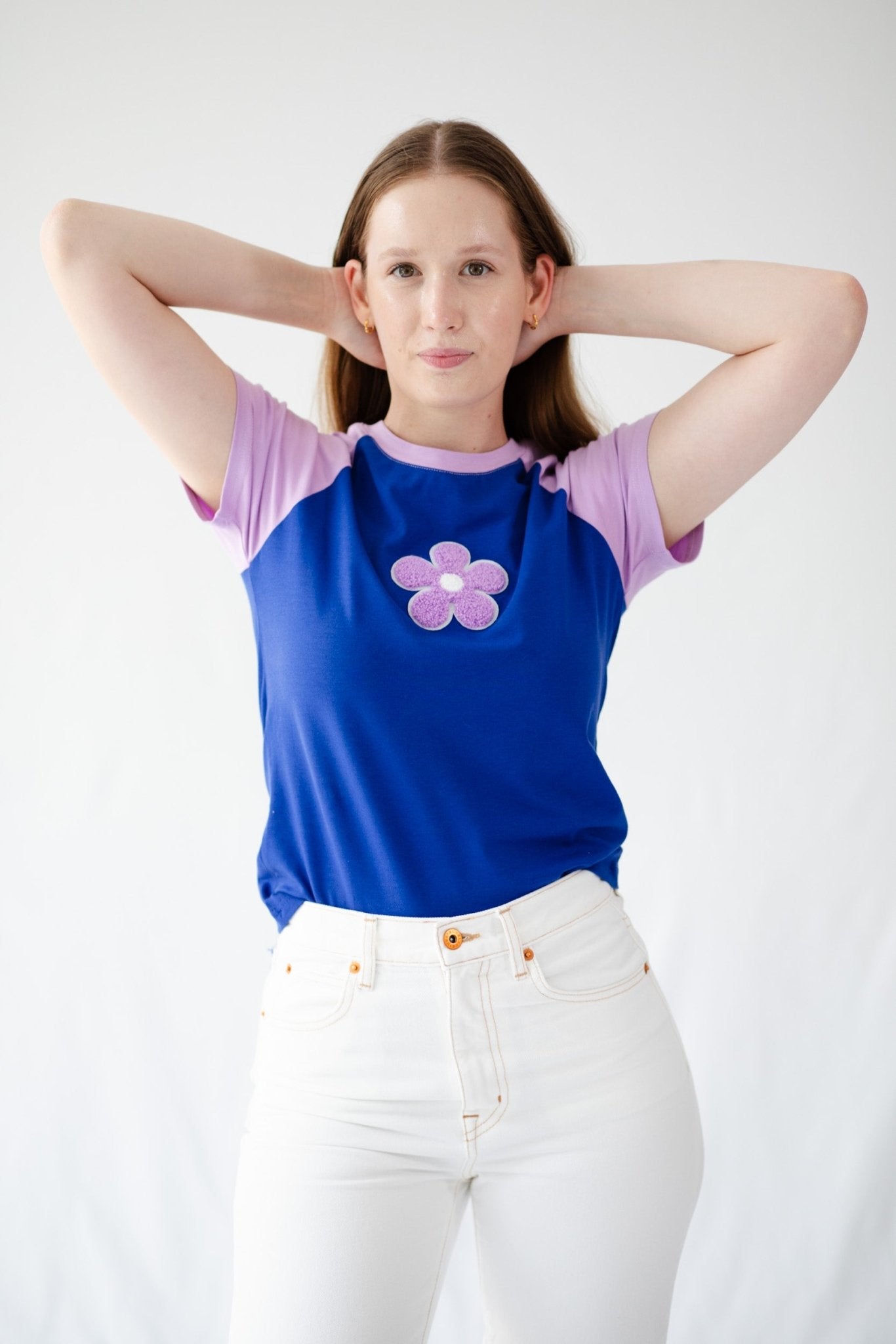 Woman wearing a lavender daisy on blue T-Shirt  - ANNIE.G