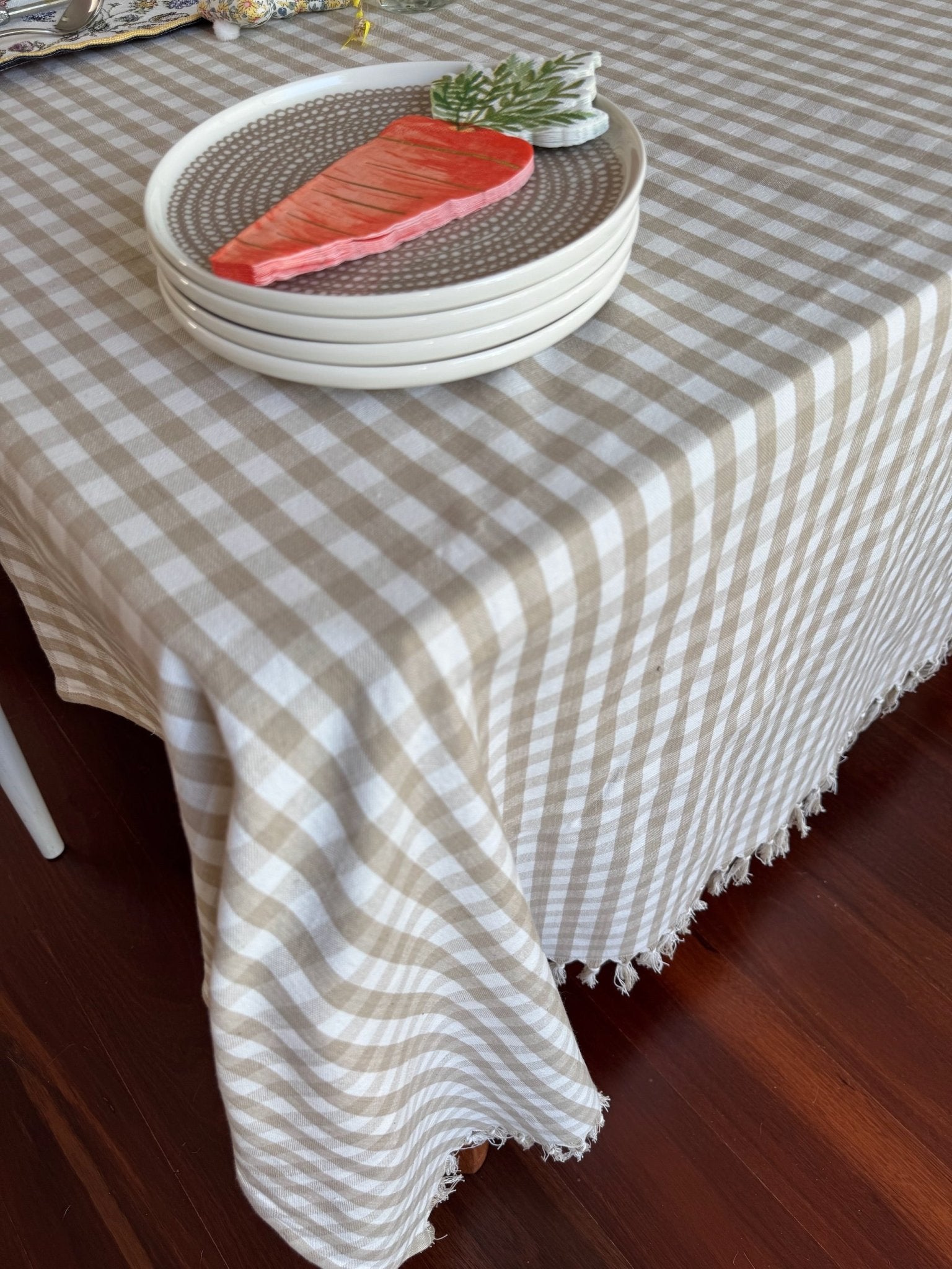 Checkered bone and white Gingham Cotton Tablecloth on table with plates and carrot napkins on top - ANNIE.G