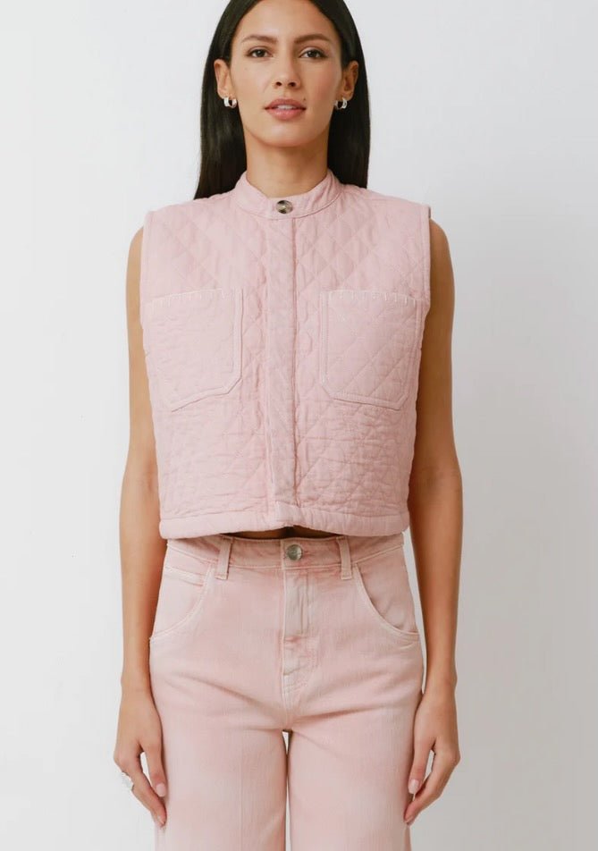 Woman wearing a pink quilted vest and pants