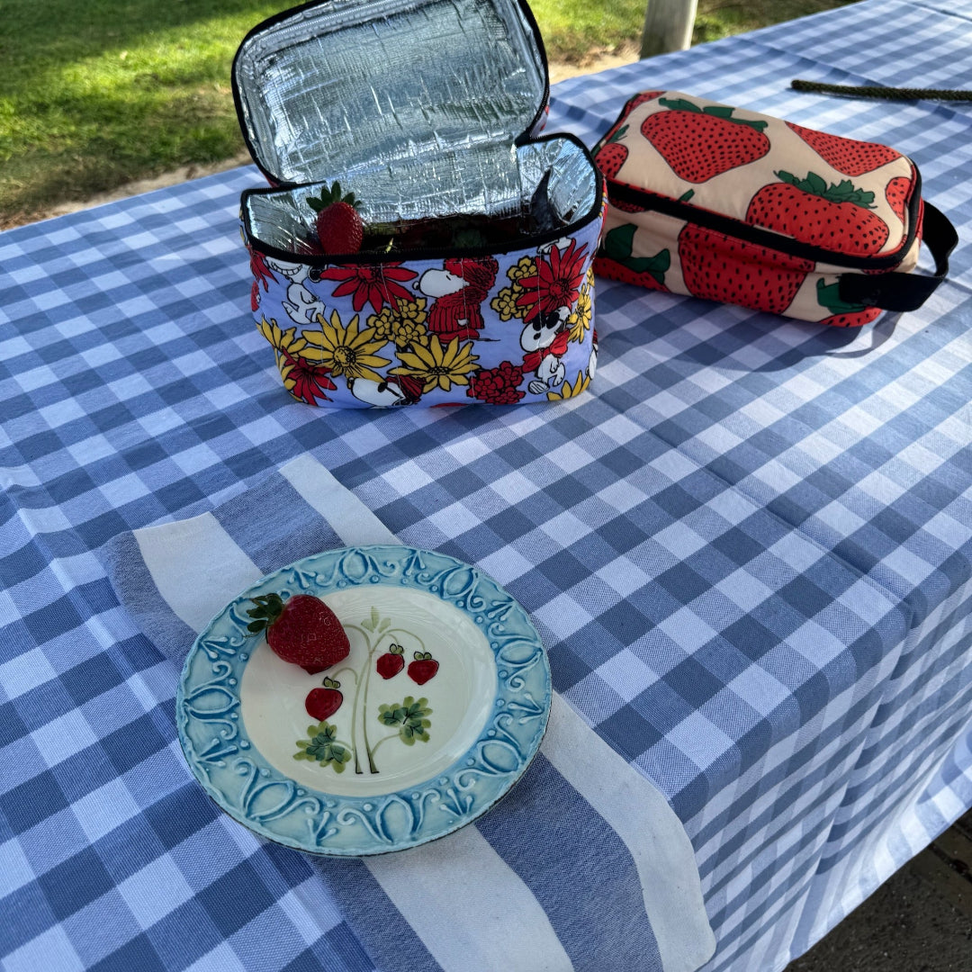 Light blue and white checked tablecloth with lunch bags and plate with a strawberry on top - ANNIE.G