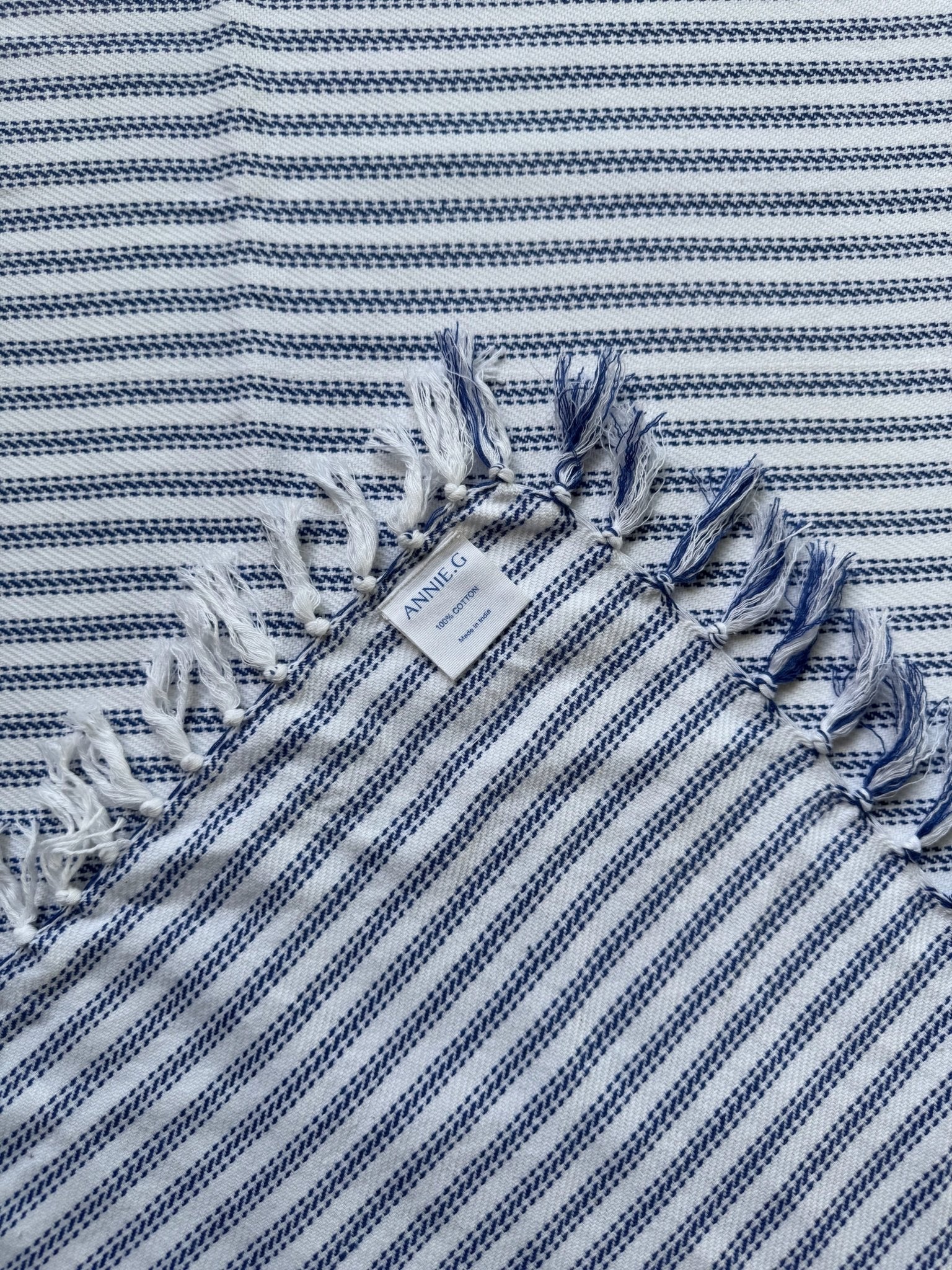 square-tablecloth-true-blue-ticking-folded-edge-showing-brand-label