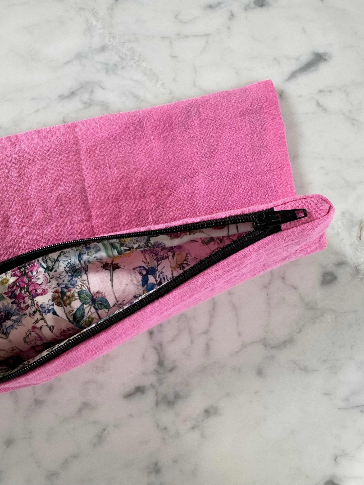 Floral lining inside pink zip top bag.