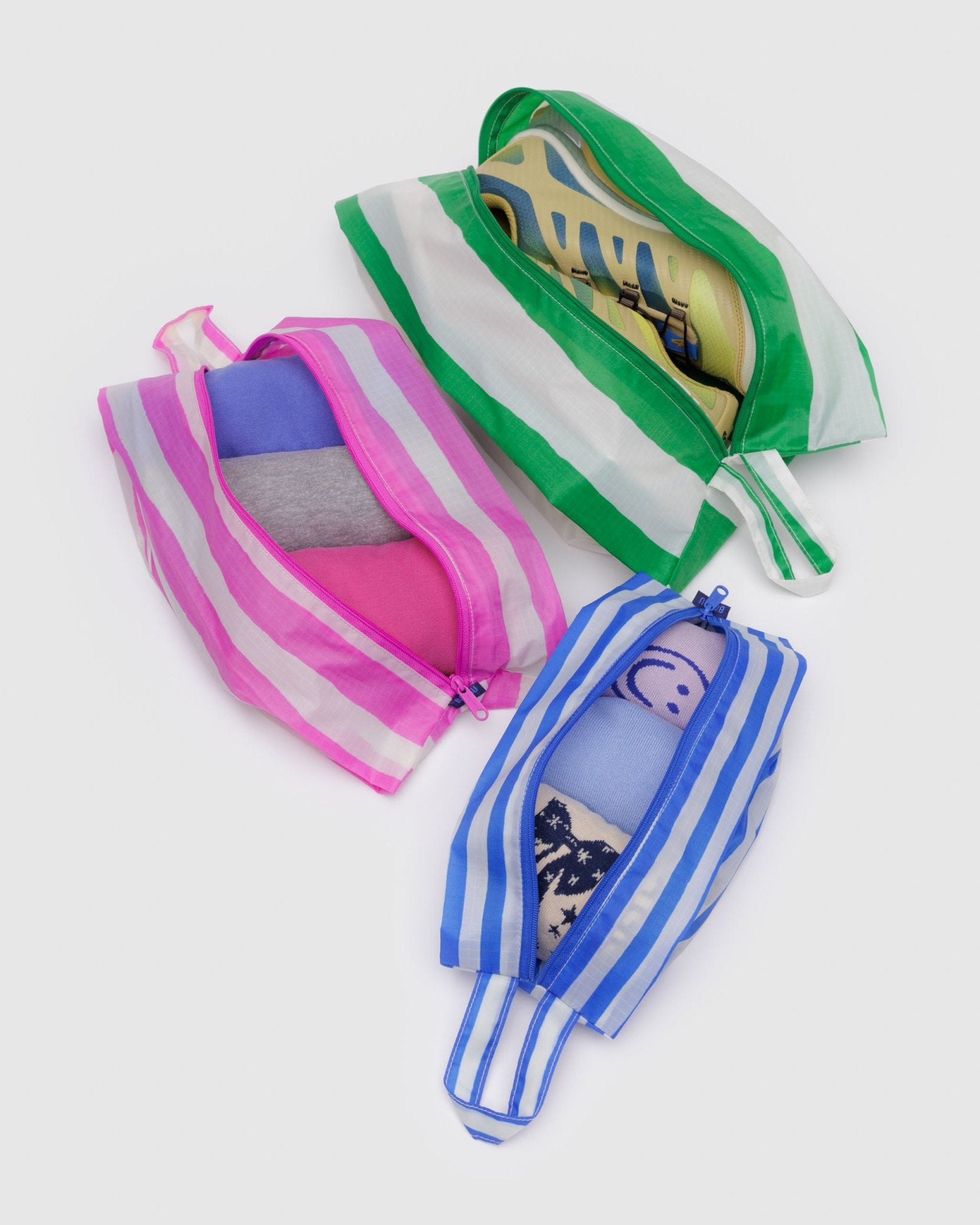 Striped set of zip top bags that expand with clothes and shoes inside each different size with a loop for hanging or carrying - ANNIE.G