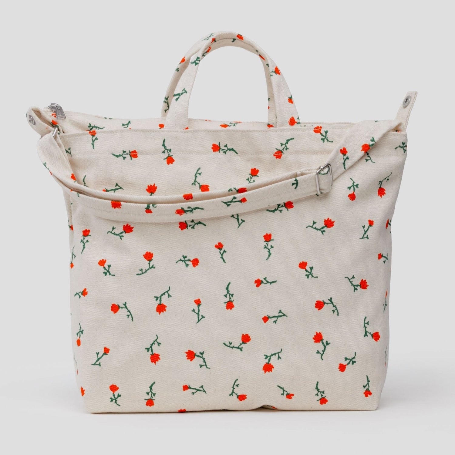 Beige tote bag with red wildflower floral pattern, adjustable shoulder strap and carry handles with zip top
