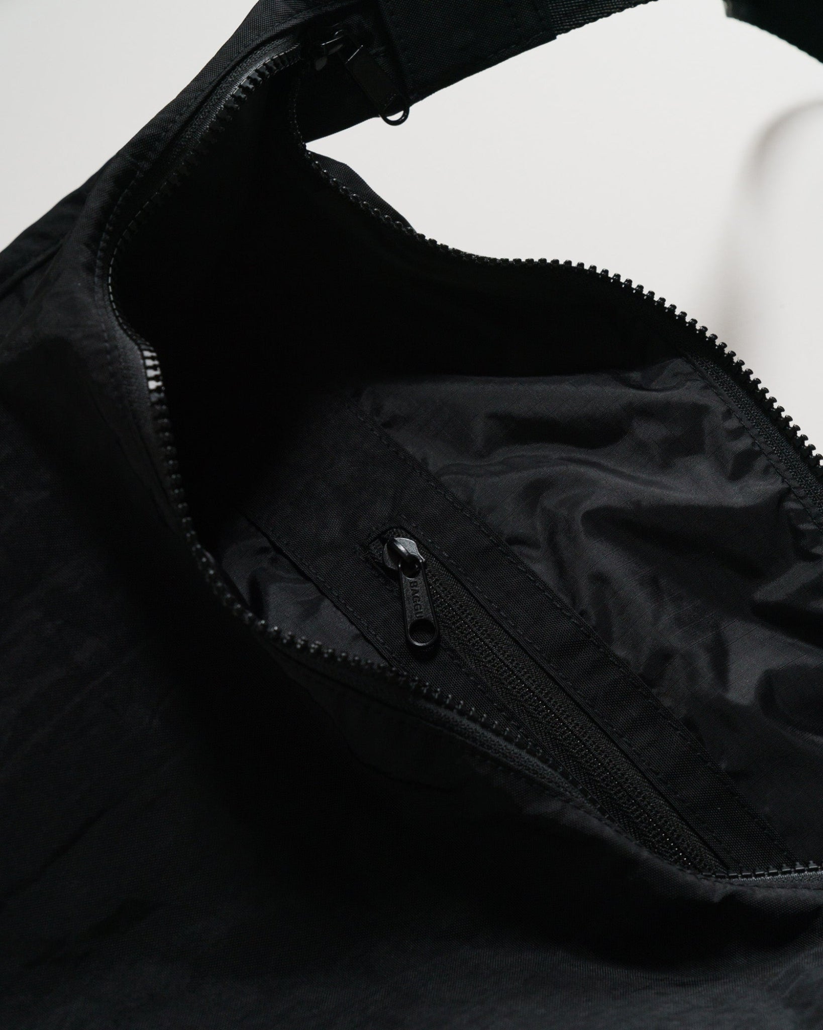 Zip pocket inside large black crescent bag- ANNIE.G