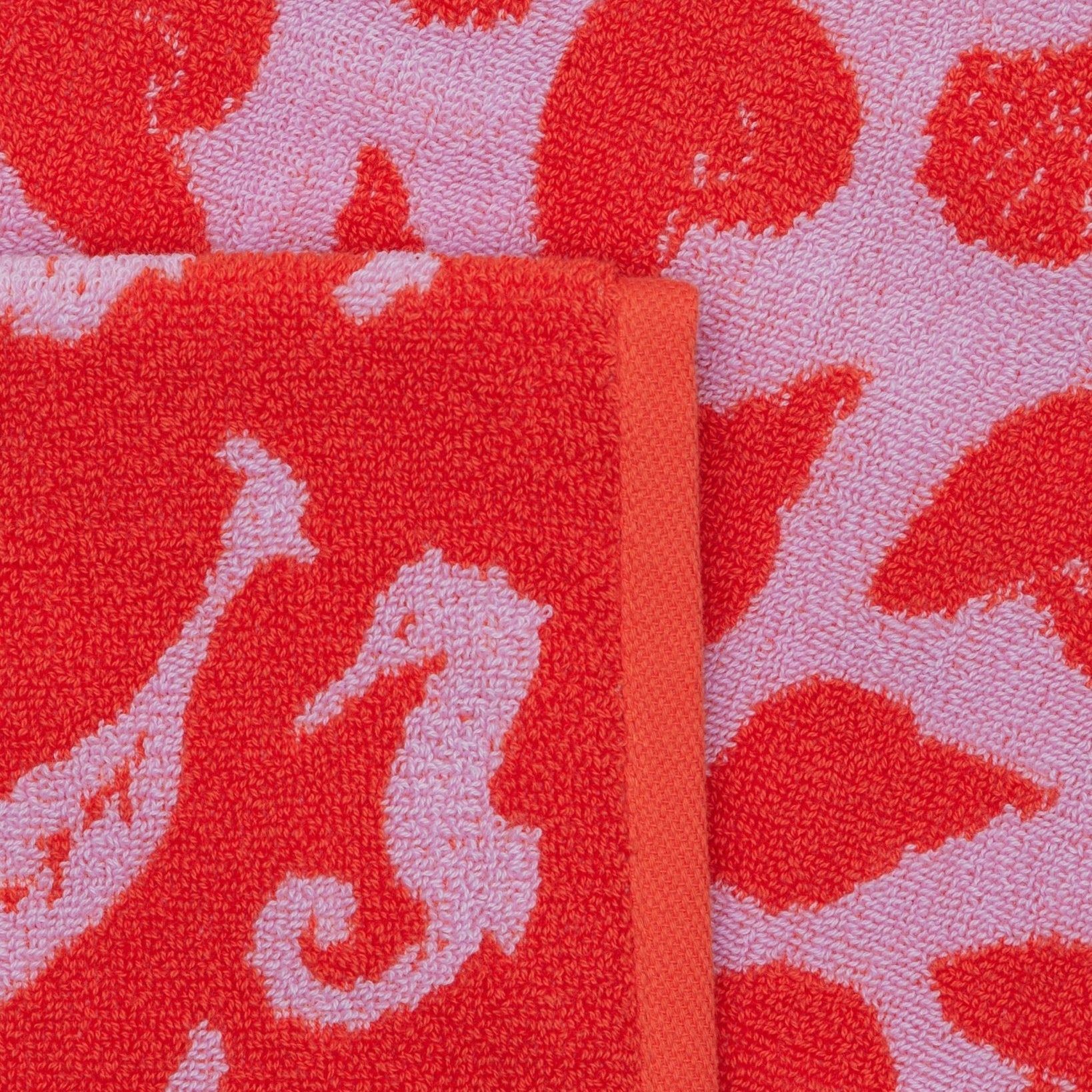 Close up of seashell print and pink and red colours of the Reversible Hand Towel Set of 2 - ANNIE.G