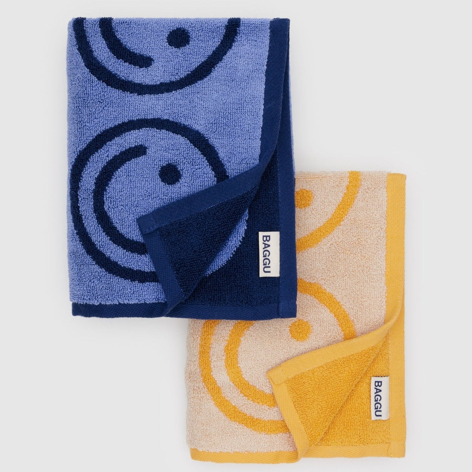 set of blue and yellow hand towels with smiley face print with BAGGU label