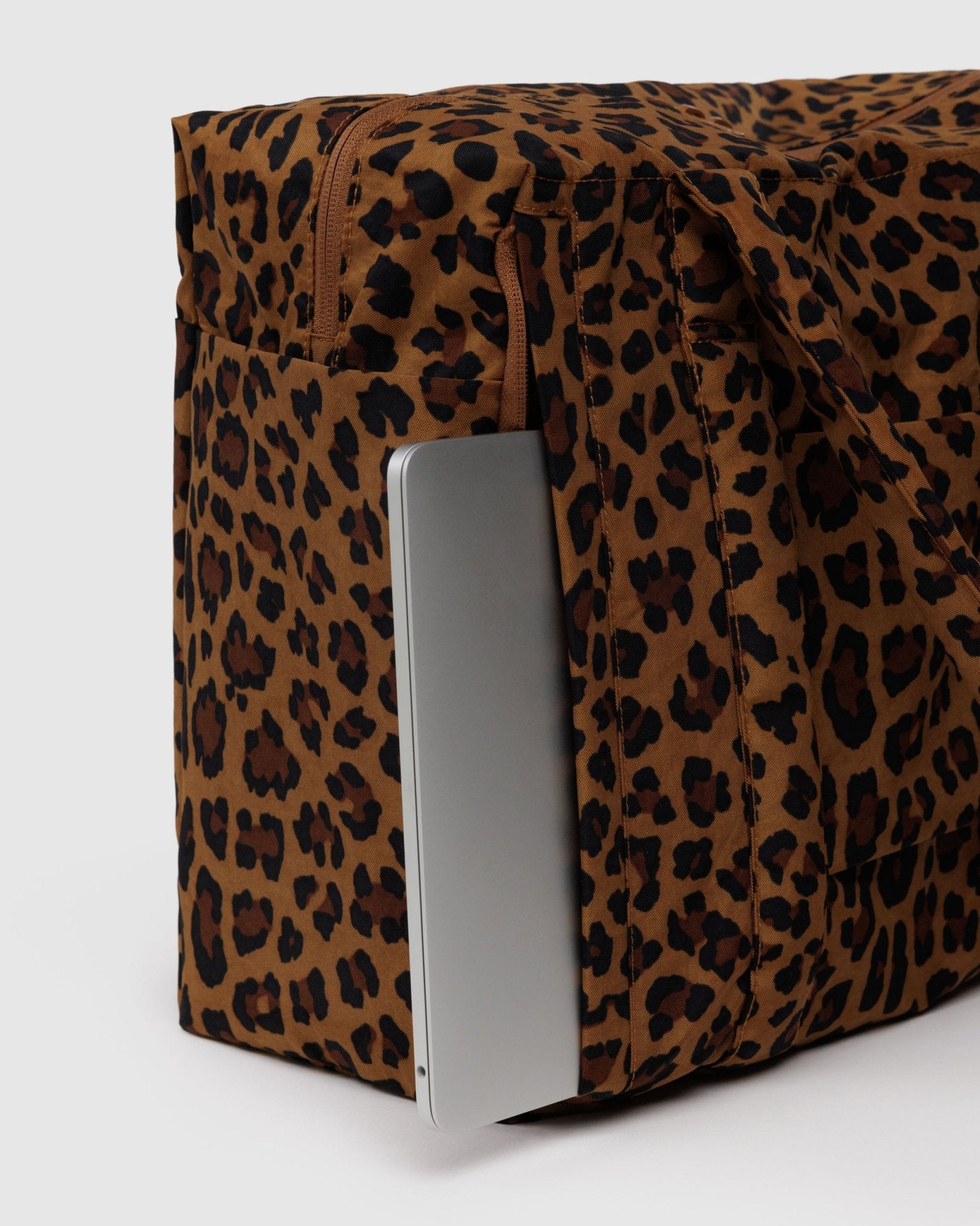 small leopard print duffle bag with laptop in side laptop pocket with zip