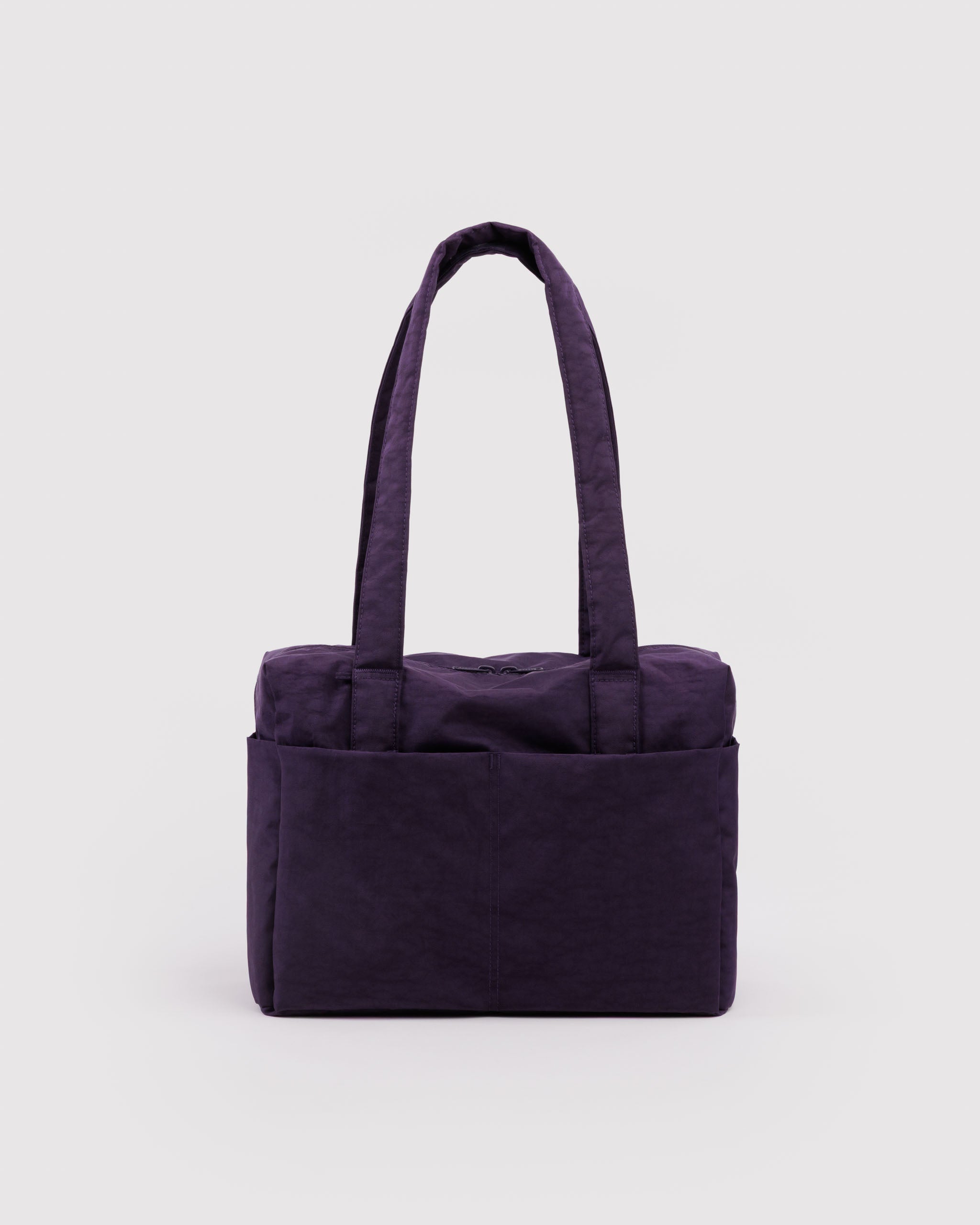 Purple duffle bag with double top zippers, two carry handles and exterior pockets.