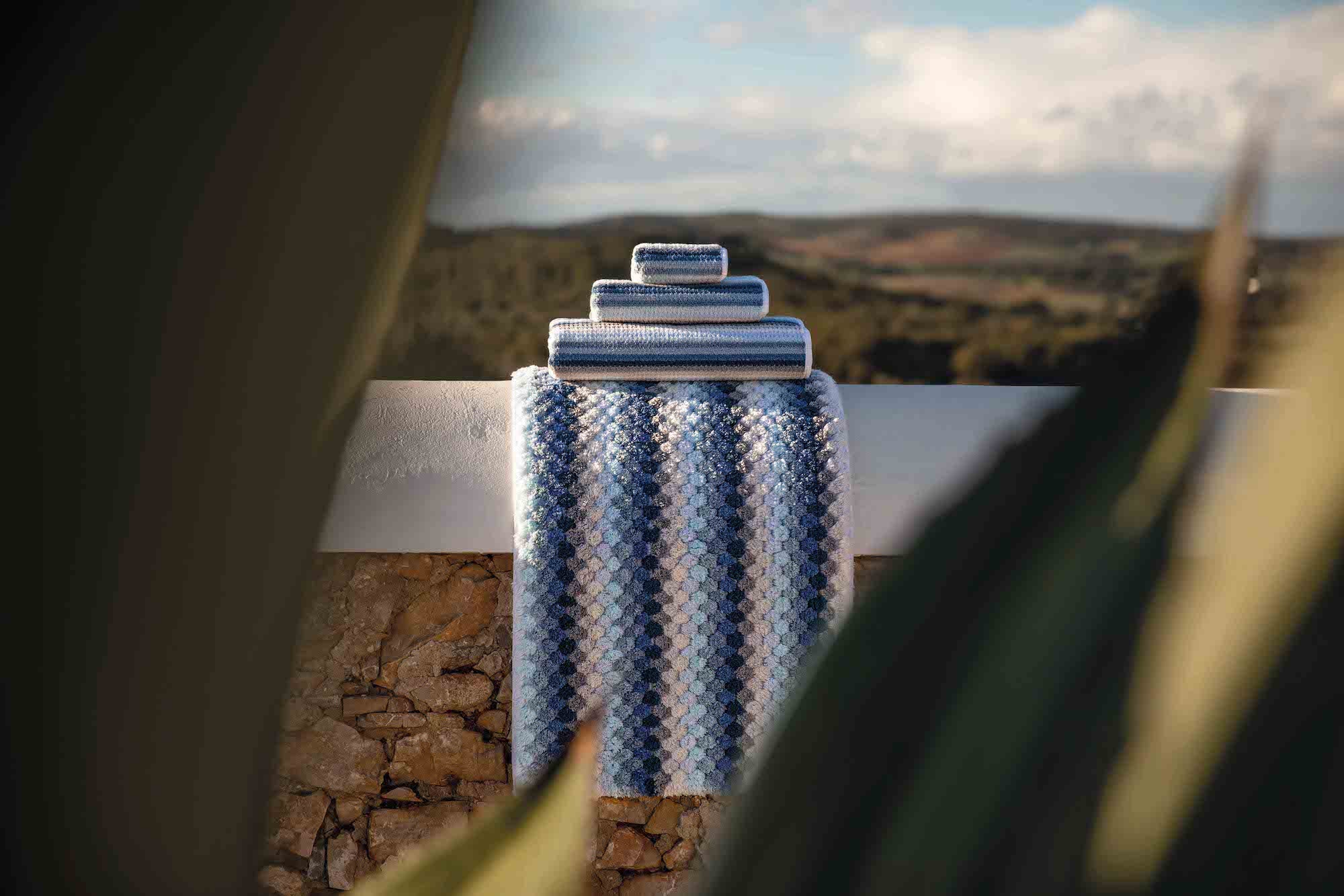 Lollypop Hand Towel collection over a white fence rail in landscape - ANNIE.G