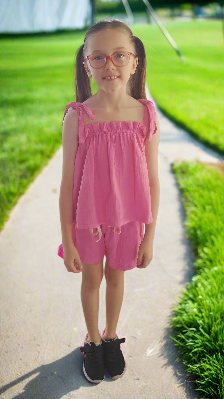 girl-wearing-hot-pink-shorts-and-top-set-standing-on-a-path 