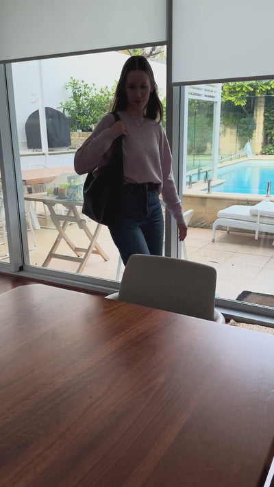 woman showing what's in work leather bag