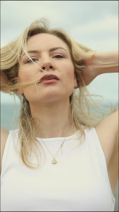 movie of women wearing the chartruese and lack gathered waist skirts near beach