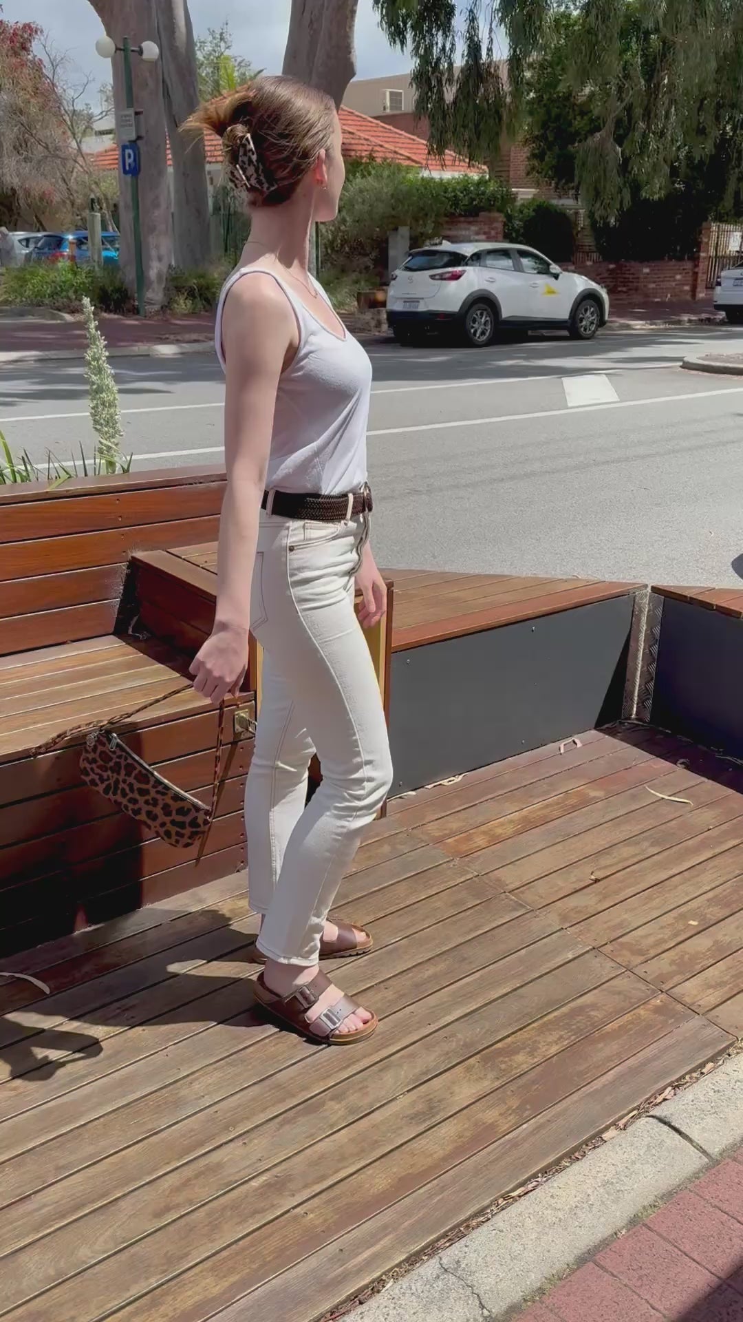 women holding leopard pochette in hand 