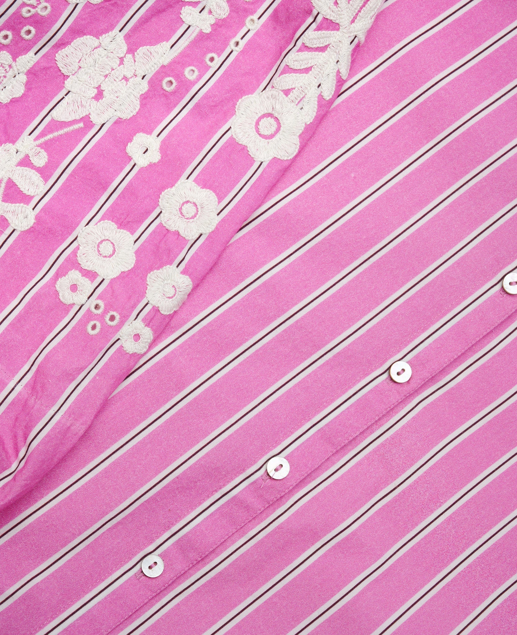 close up of pink stripe fabric and embroidery sleeve detail.