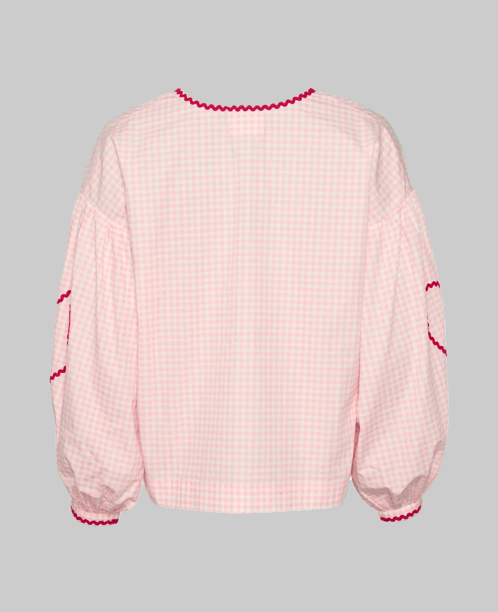 Back of pink checked blouse with long sleeves and red ric rac detail at cuffs and elbows.