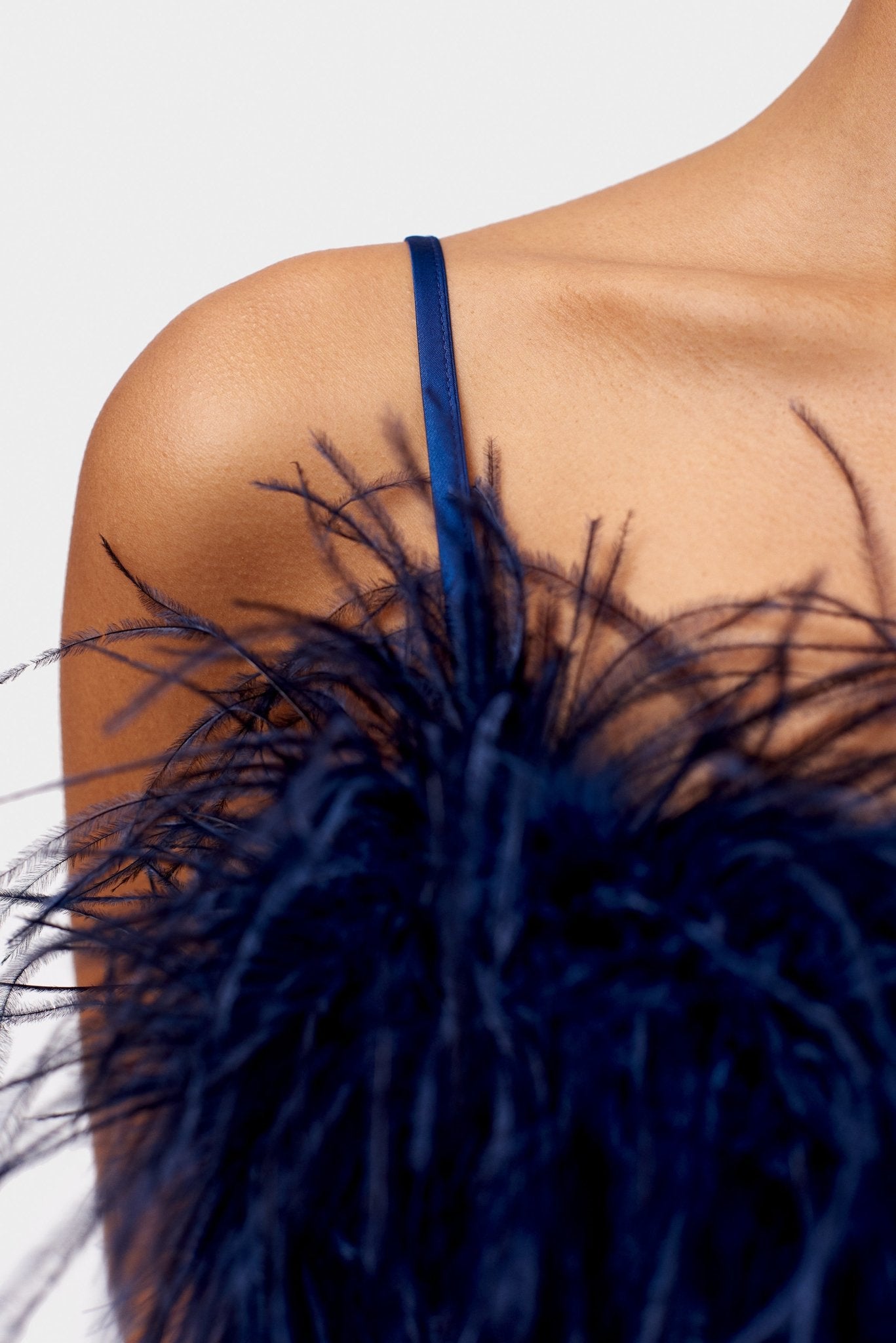Navy feathers on navy slip dress with spaghetti strap.
