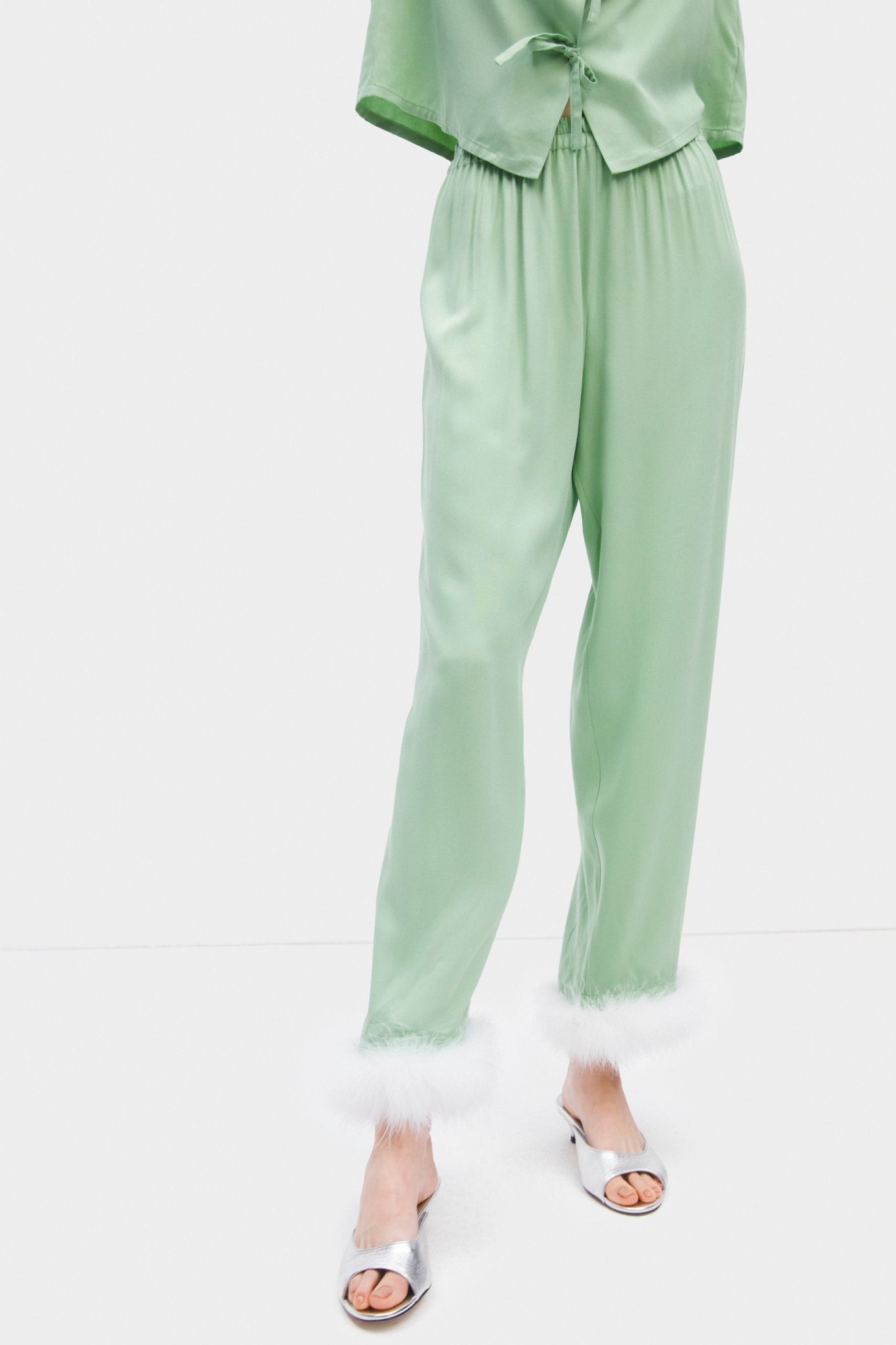 Close up of person wearing pyjama pants in mint with white feather cuffs - ANNIE.G
