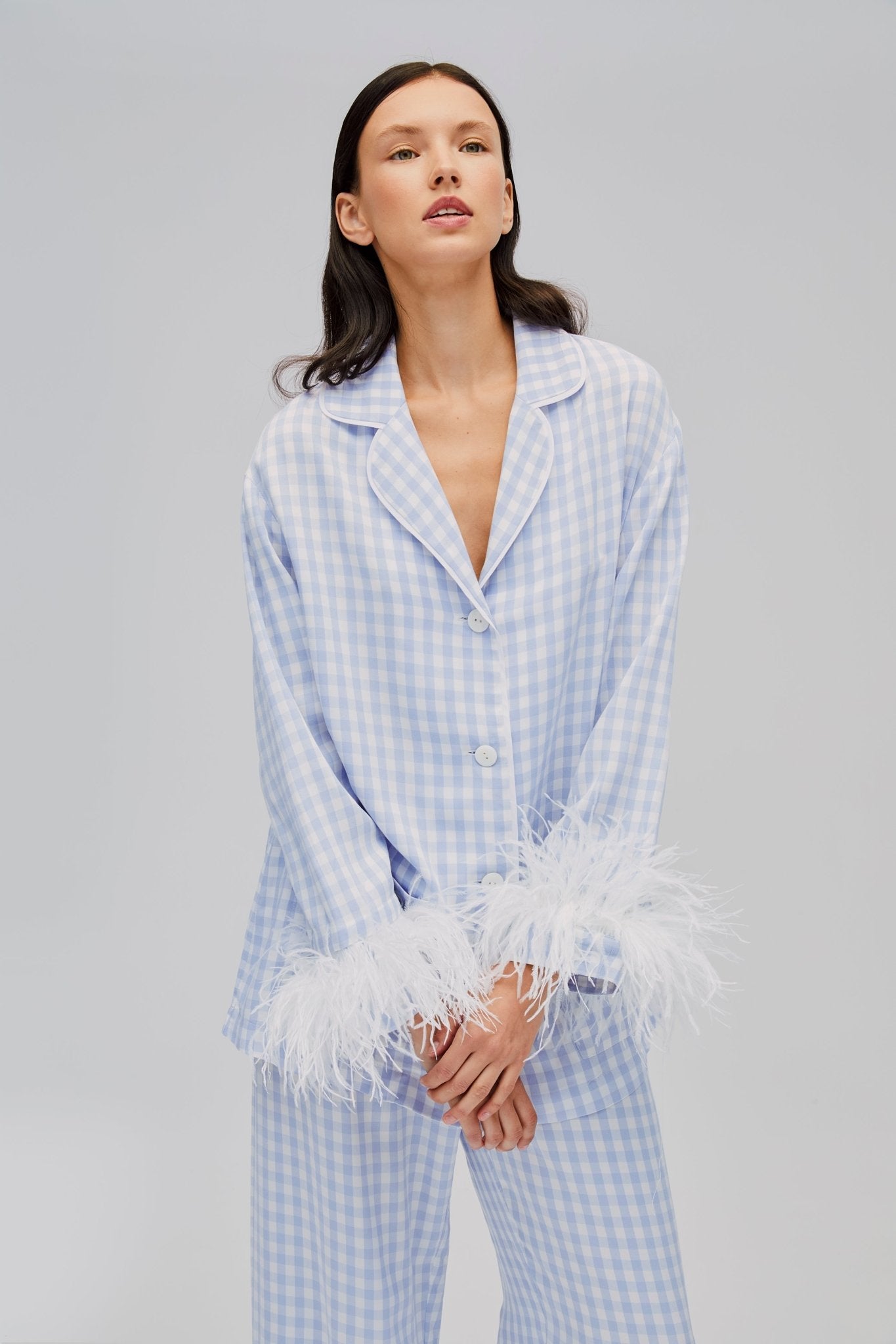 Woman wearing blue gingham Party Pyjamas Set long sleeve shirt with Detachable Feathers and front buttons and matching pants