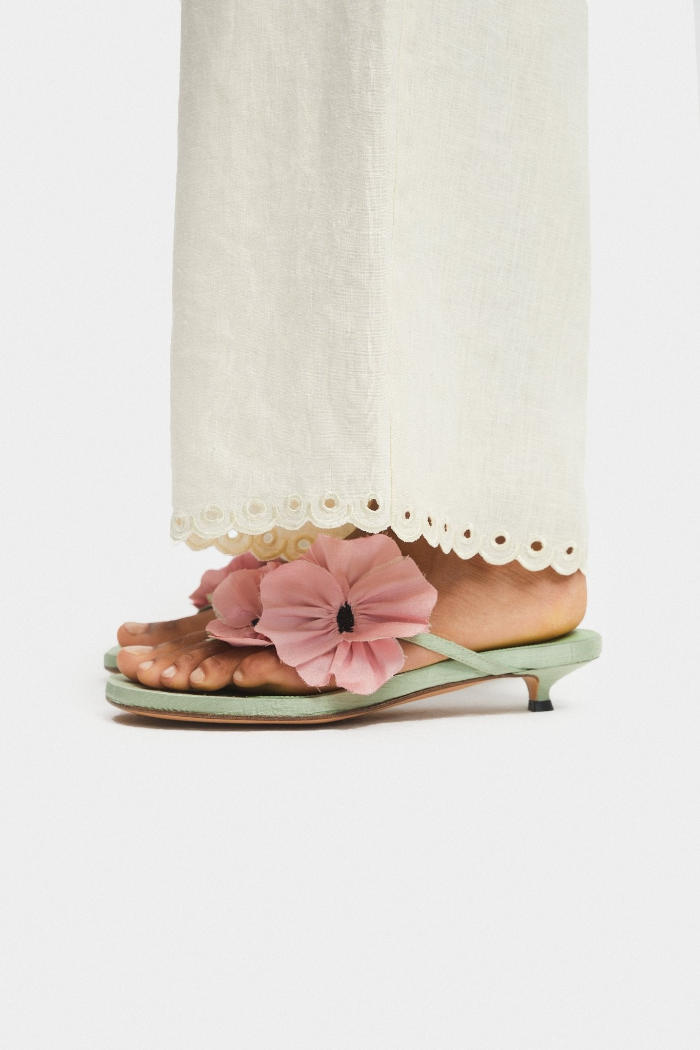 Close up of scalloped hem embroidery on cream pants - ANNIE.G