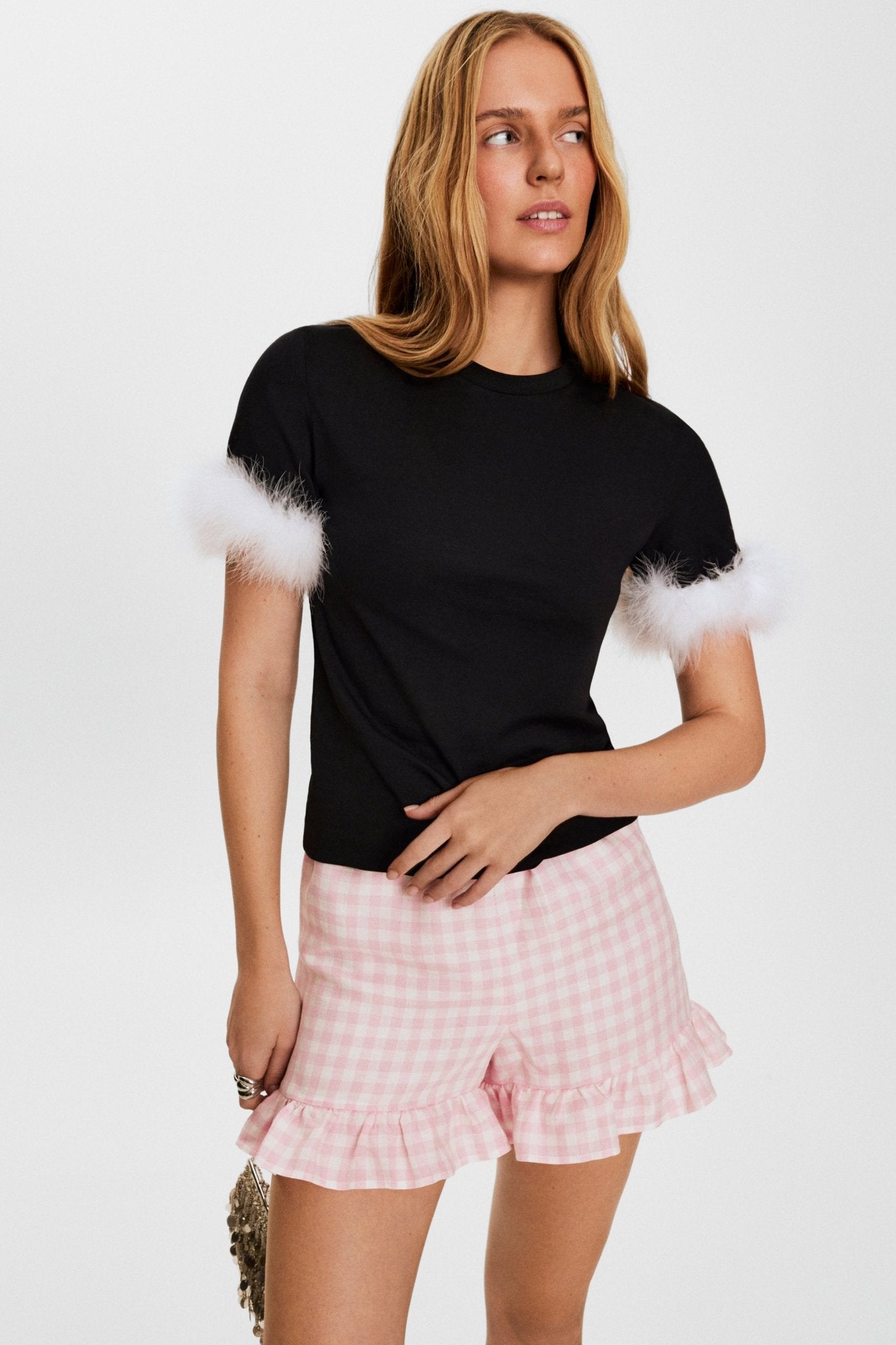 woman-wearing-black-jersey-cotton-tee-in-black-with-detachable-white-feathers-and-chacha-pink-vichy-shorts